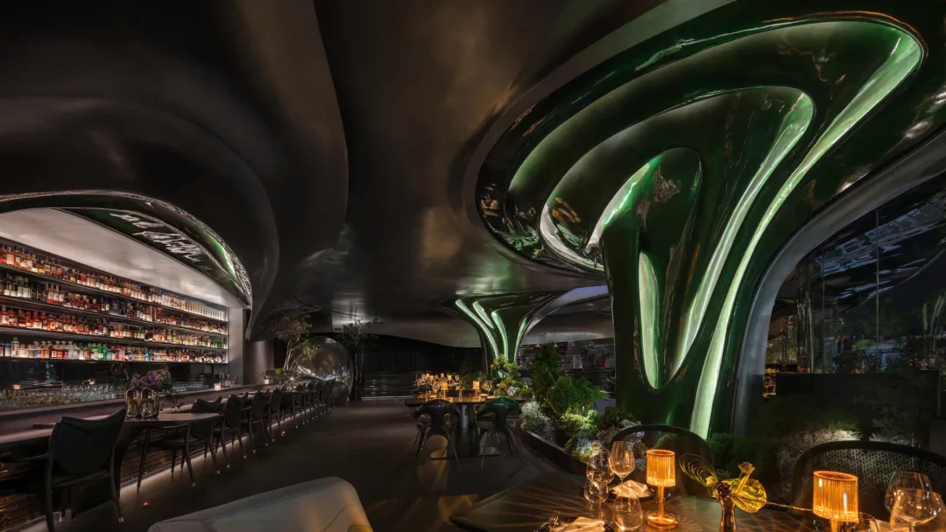 A modern restaurant interior with a dining table, chairs, and wine glasses, creating a sophisticated and inviting atmosphere