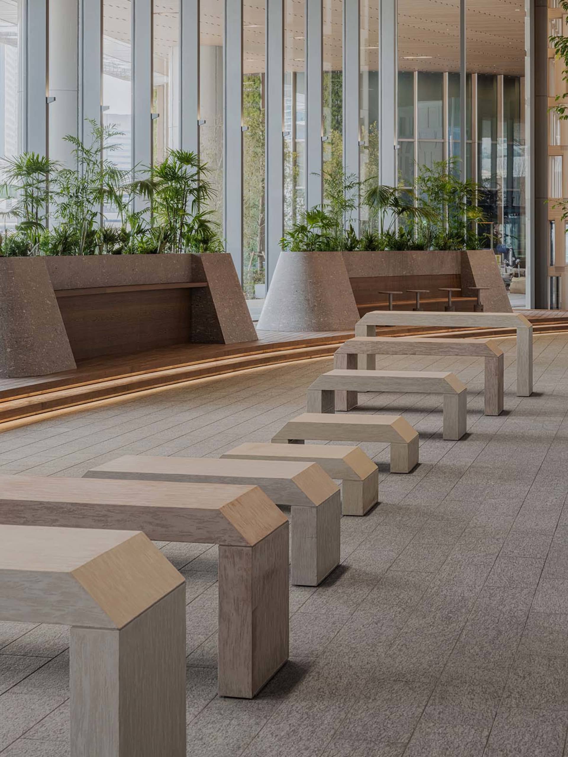 A public space with several wooden benches in various positions, creating a comfortable and inviting atmosphere for relaxation and socialization