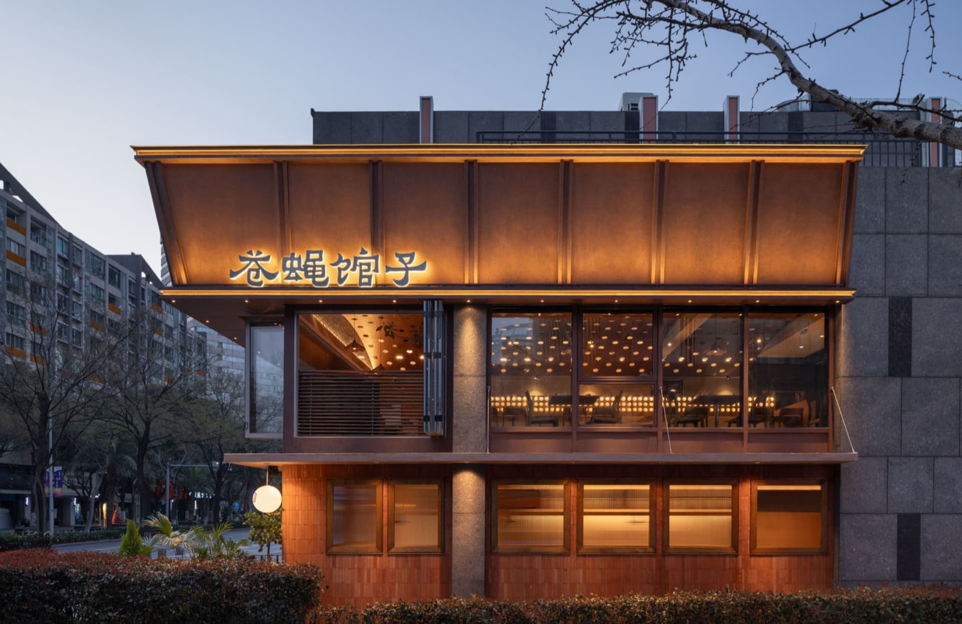 Cozy Asian restaurant with a wooden exterior, stone accents, and a warm atmosphere, featuring dining tables and natural light