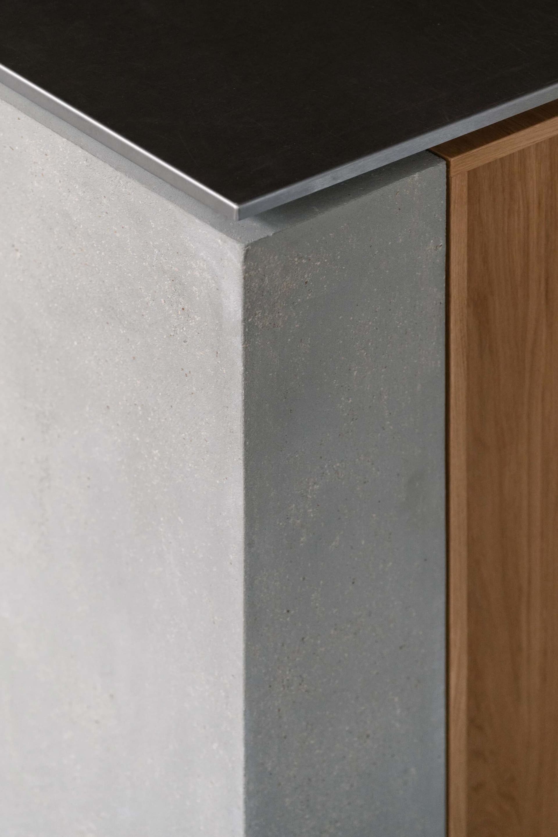 Modern room with concrete and wood walls, metal accents, and a gray and brown color scheme