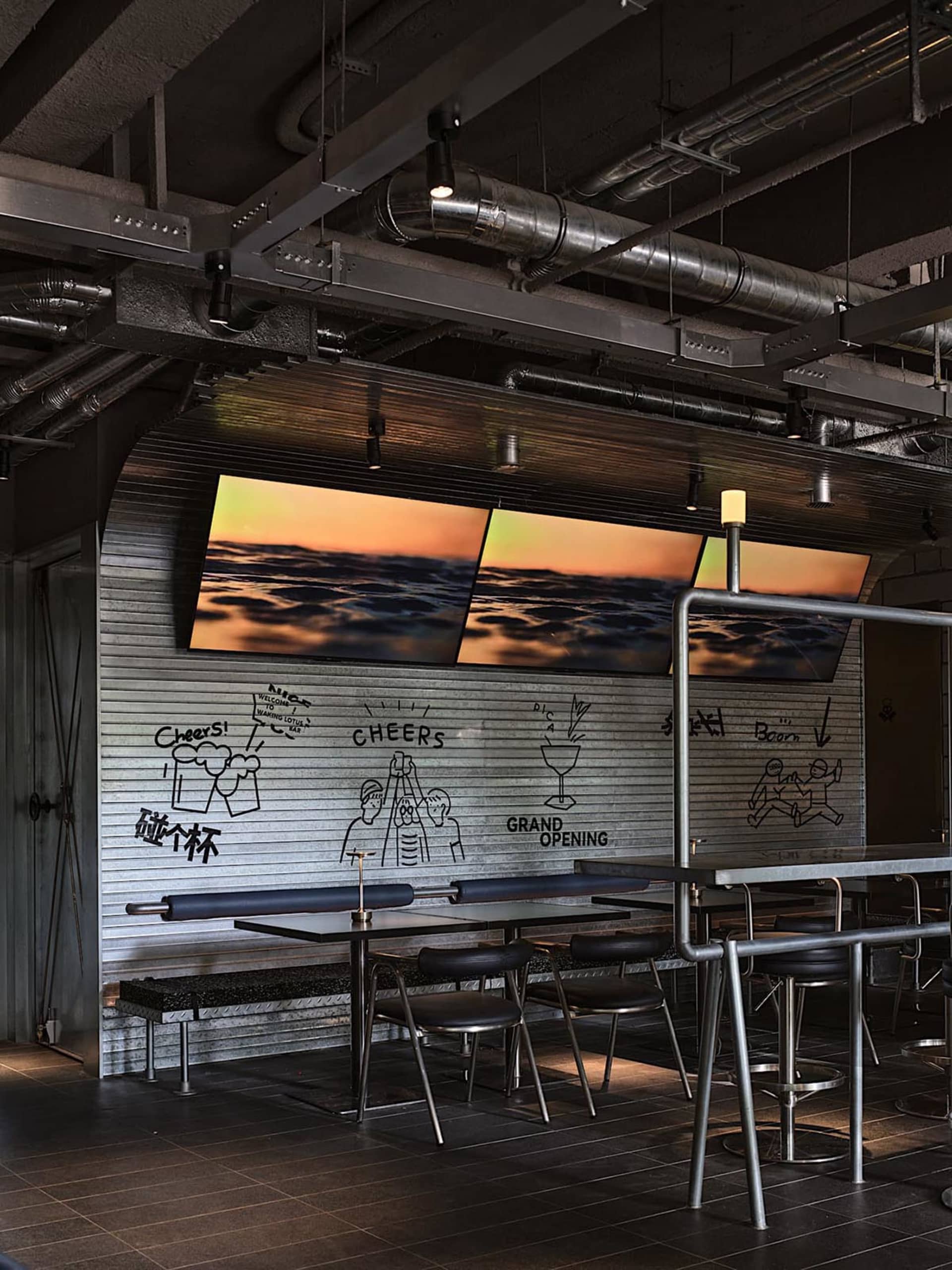 A casual dining space with a metal table and three chairs, surrounded by a modern atmosphere