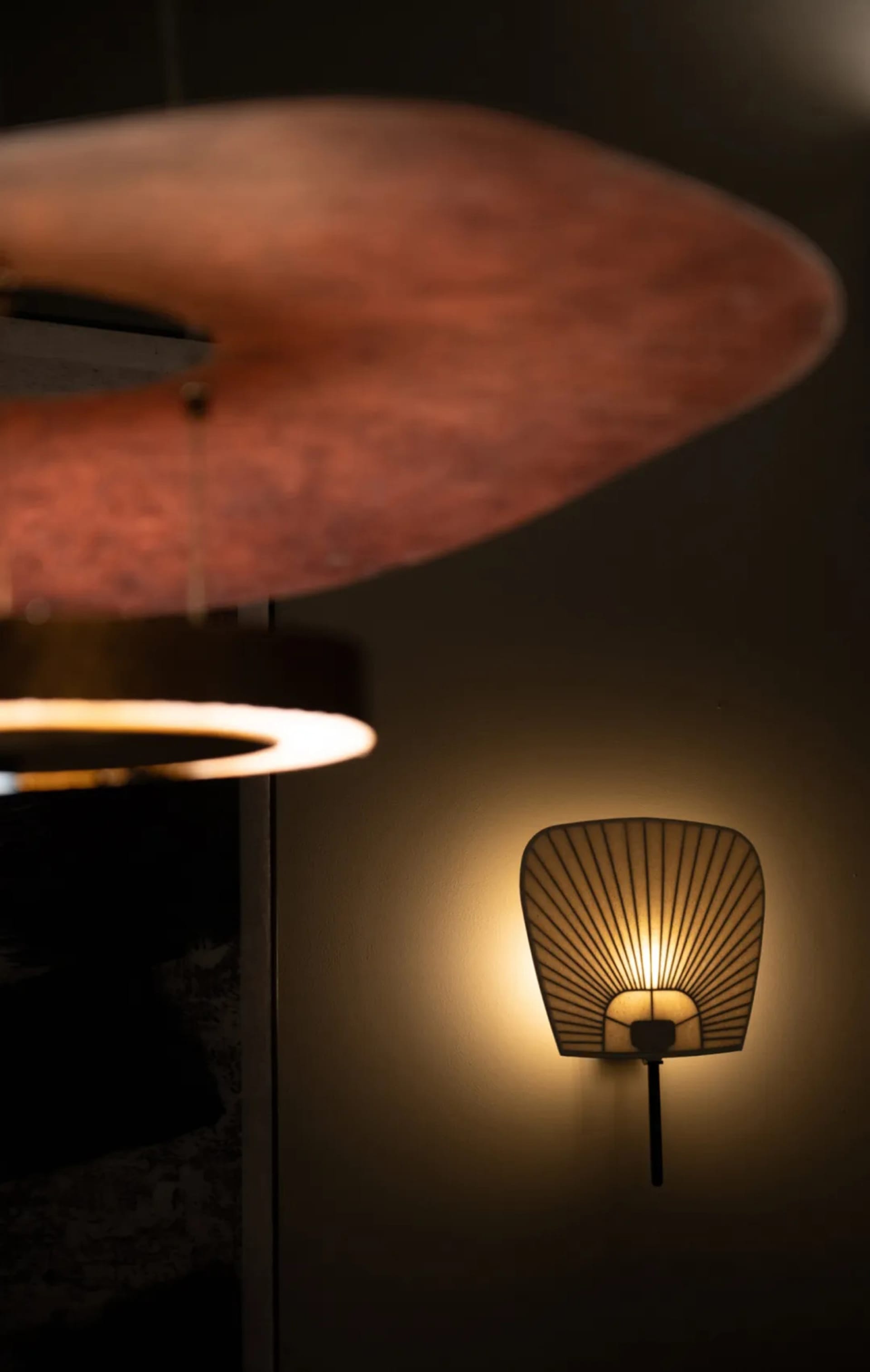 Two modern lamps with wooden and metal components sit on a stylish interior space with a modern aesthetic