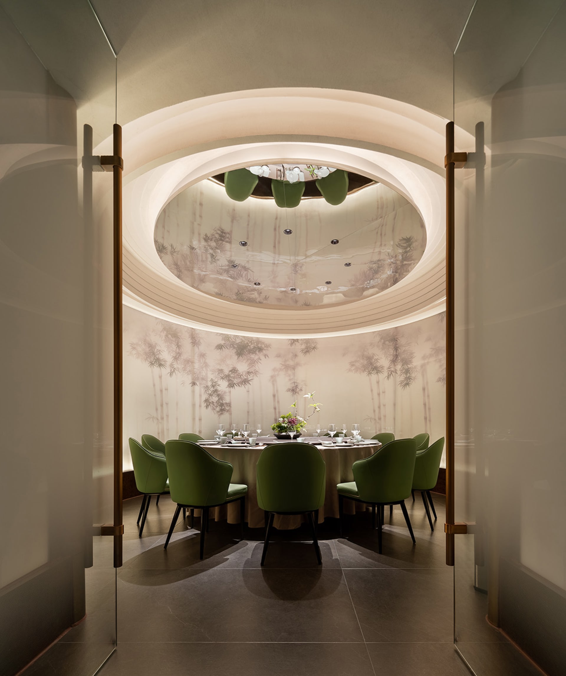 Elegant dining space with a round table, chairs, and wine glasses, set in a comfortable and inviting atmosphere