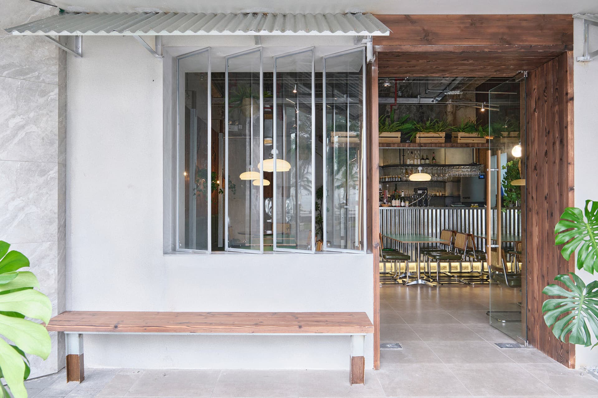 Casual restaurant bar area with dining tables, chairs, and backpacks, set in a relaxed atmosphere