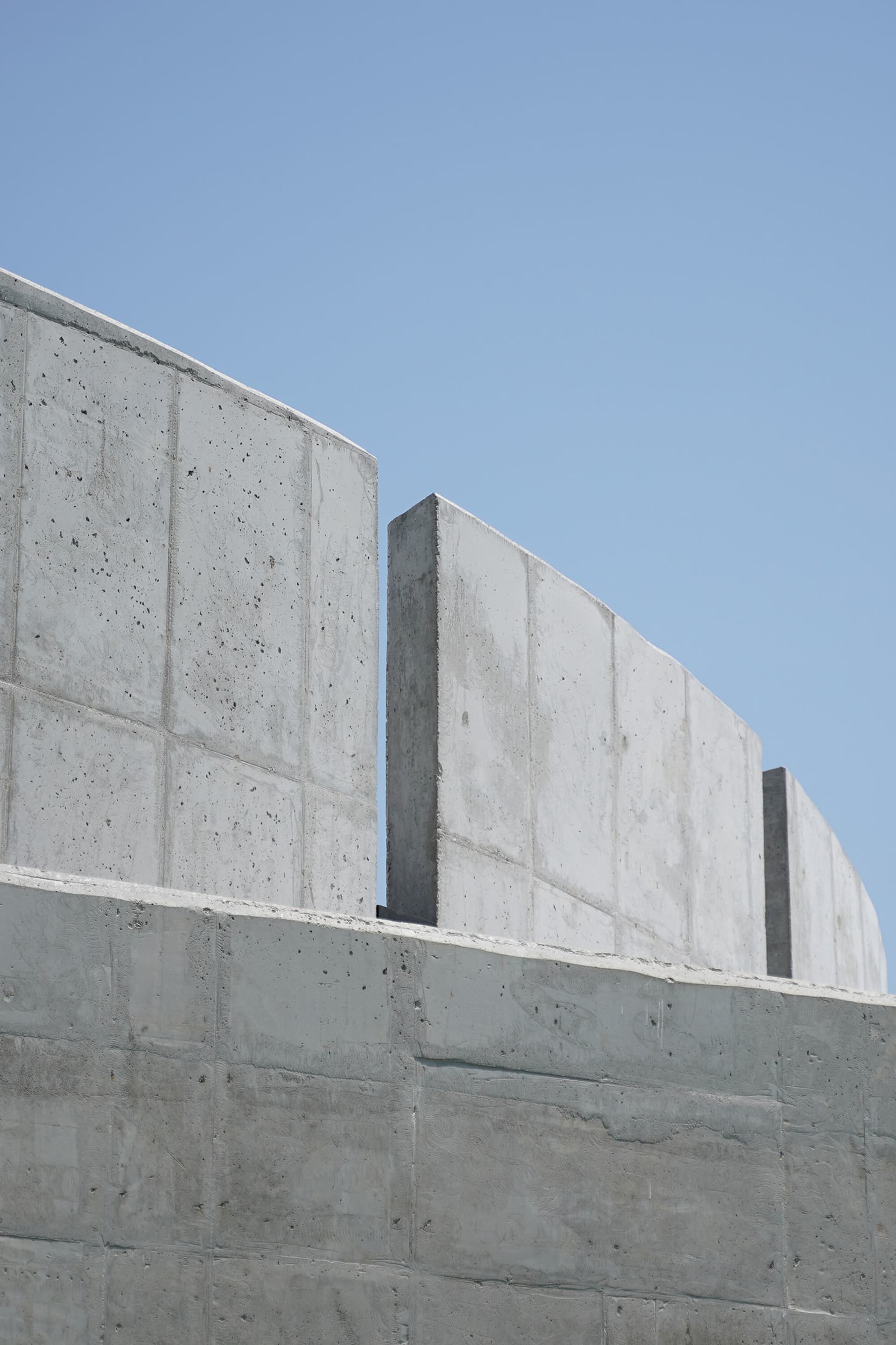 A modern building with concrete walls and a cement structure, featuring a minimalist and functional design