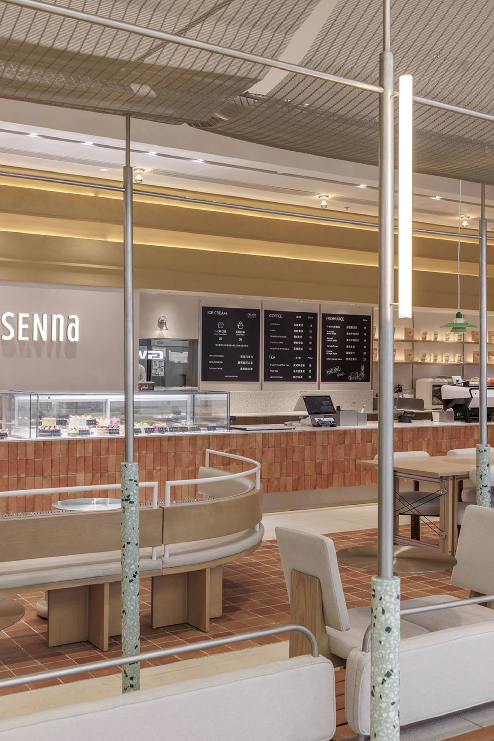 Warm and inviting Italian restaurant with a modern twist, featuring a counter with displayed food, natural light, and comfortable seating