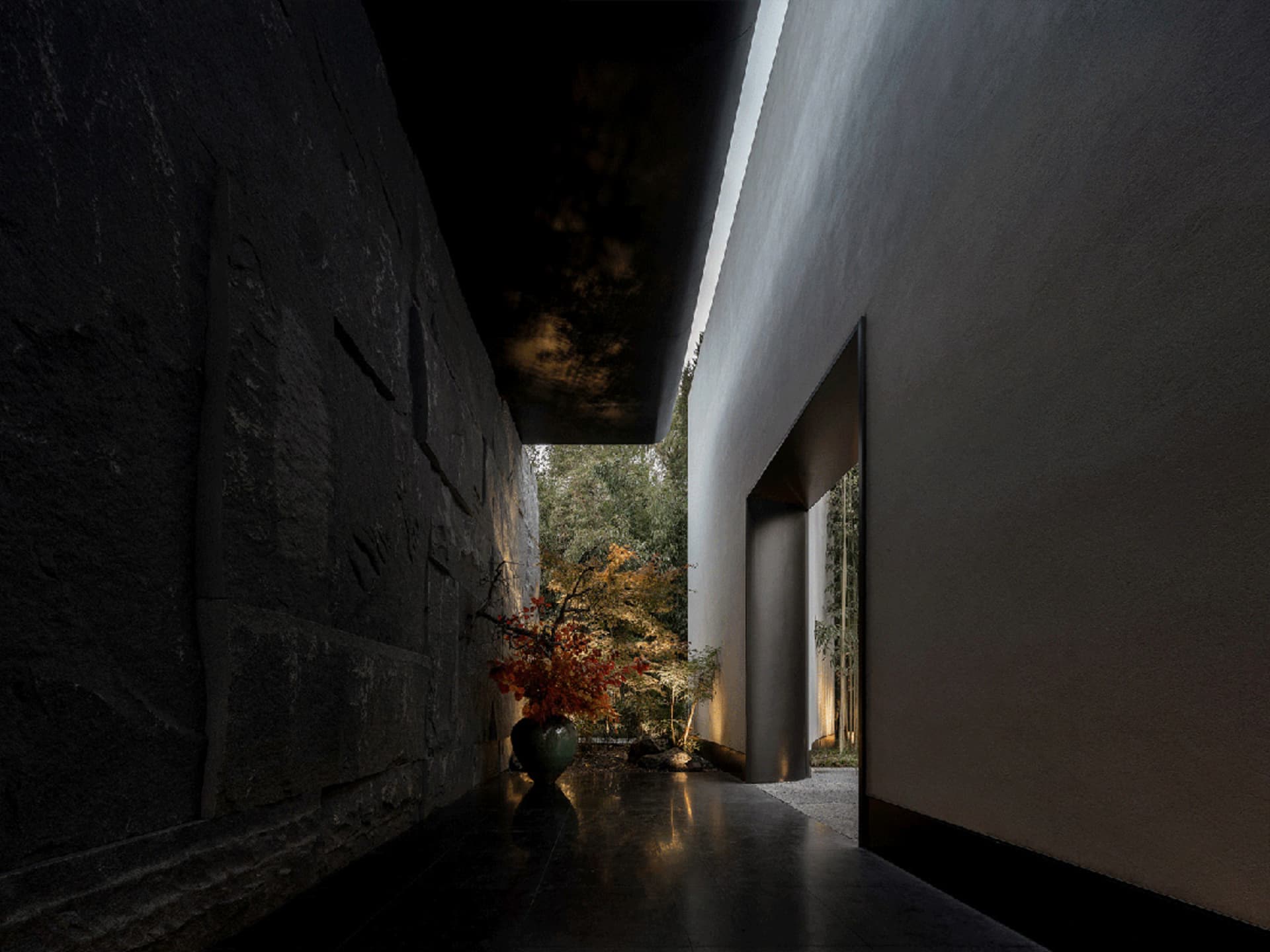 A modern hallway with a stone wall and a glass wall, featuring two potted plants and a vase, adding greenery and decoration