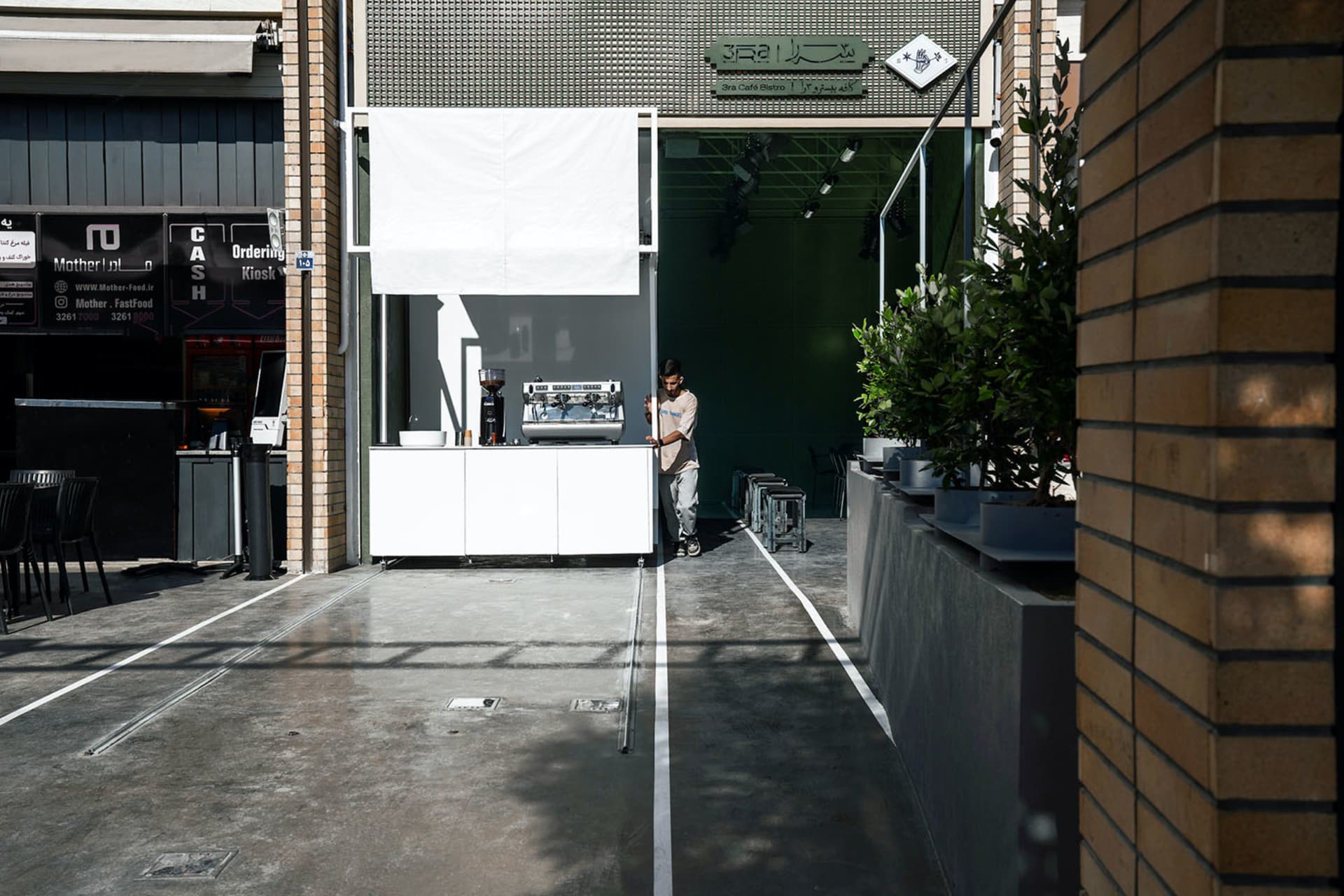 A casual commercial space with a white counter, chairs, and cups, creating a welcoming atmosphere for patrons