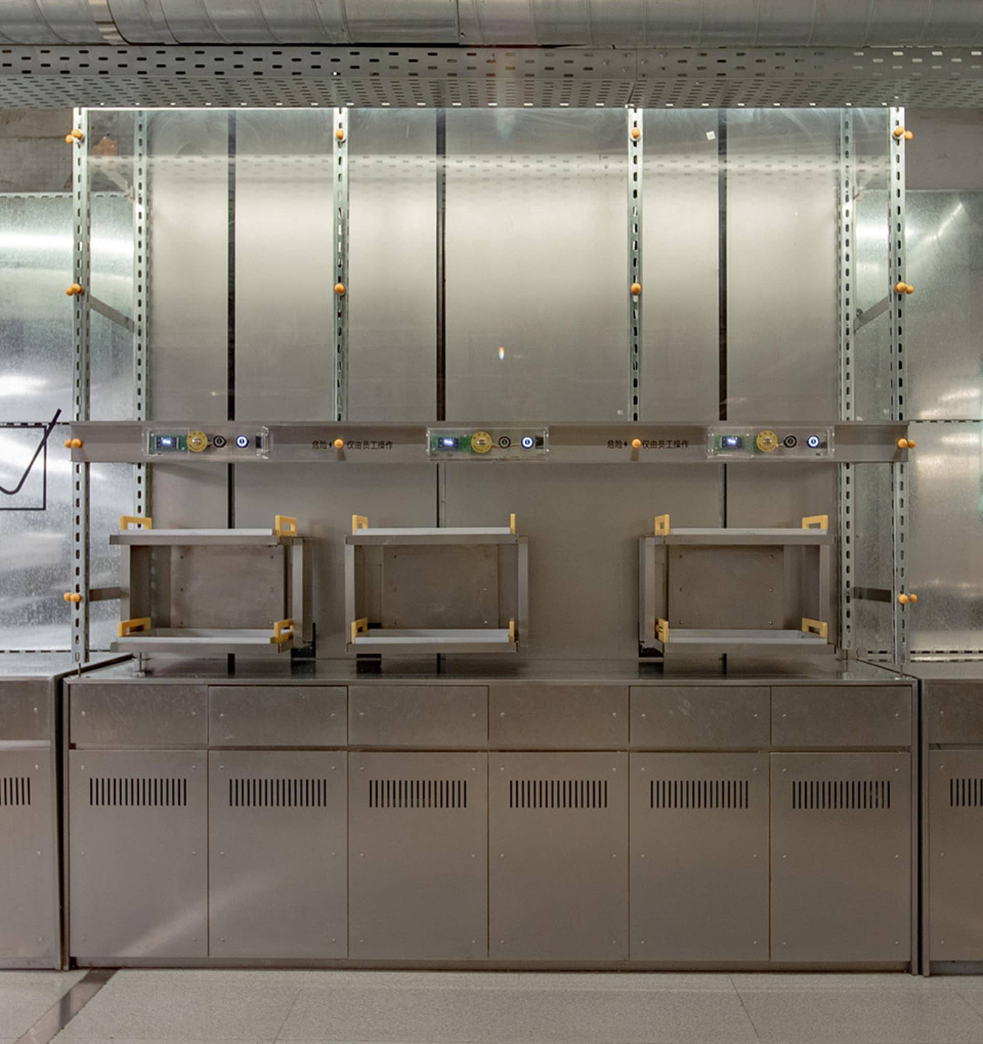 Industrial kitchen with stainless steel ovens, shelves, and cabinets, giving a professional and functional feel