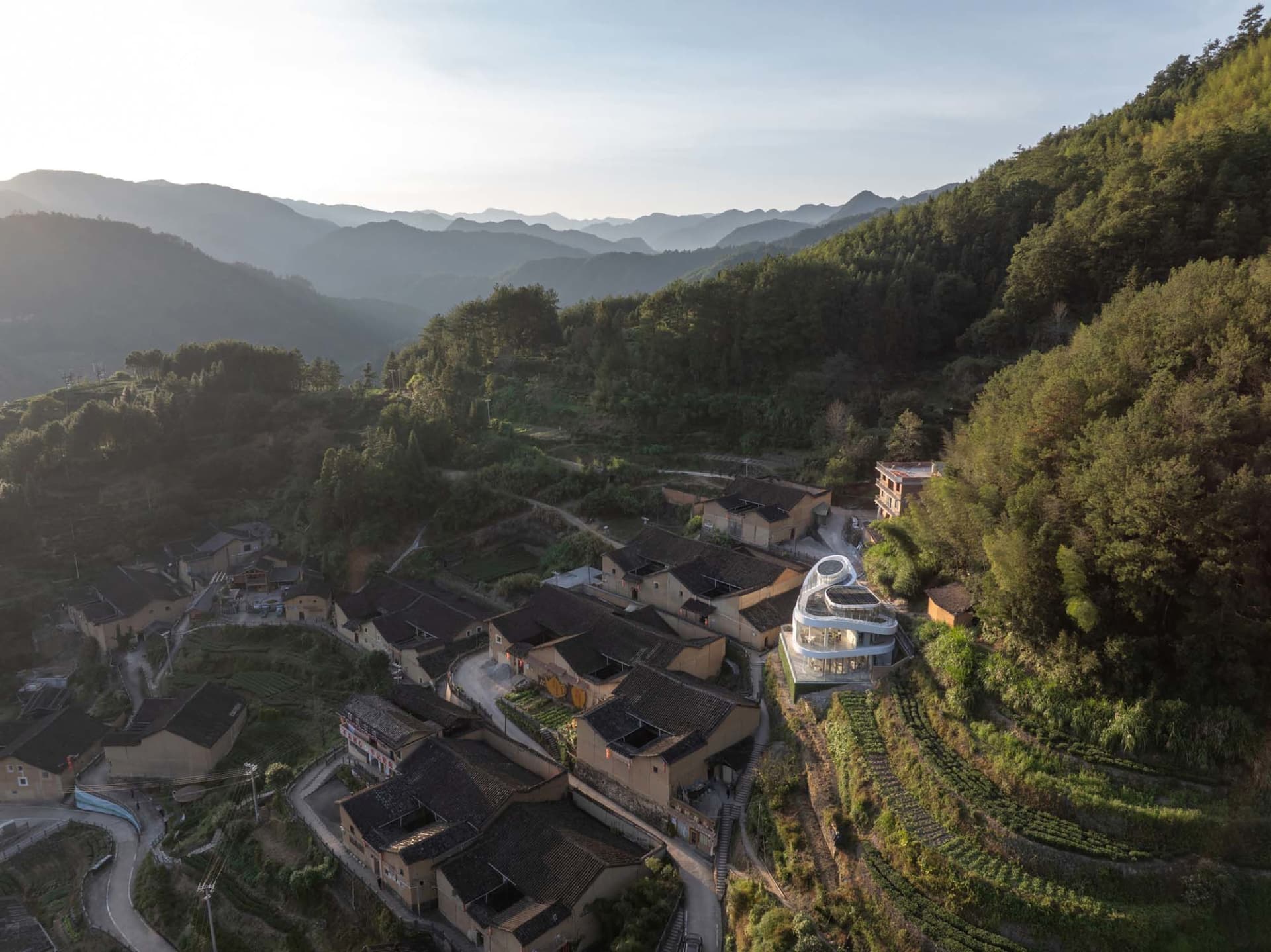 A picturesque village built into a hillside with stone buildings and a serene atmosphere