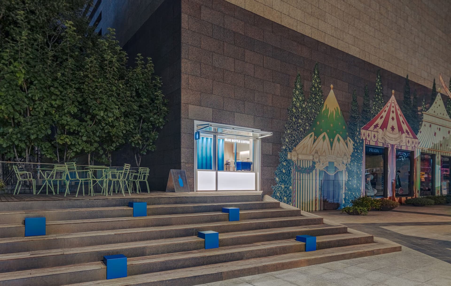 A modern cafe with a mix of modern and traditional elements, featuring a large window, dining tables, and chairs