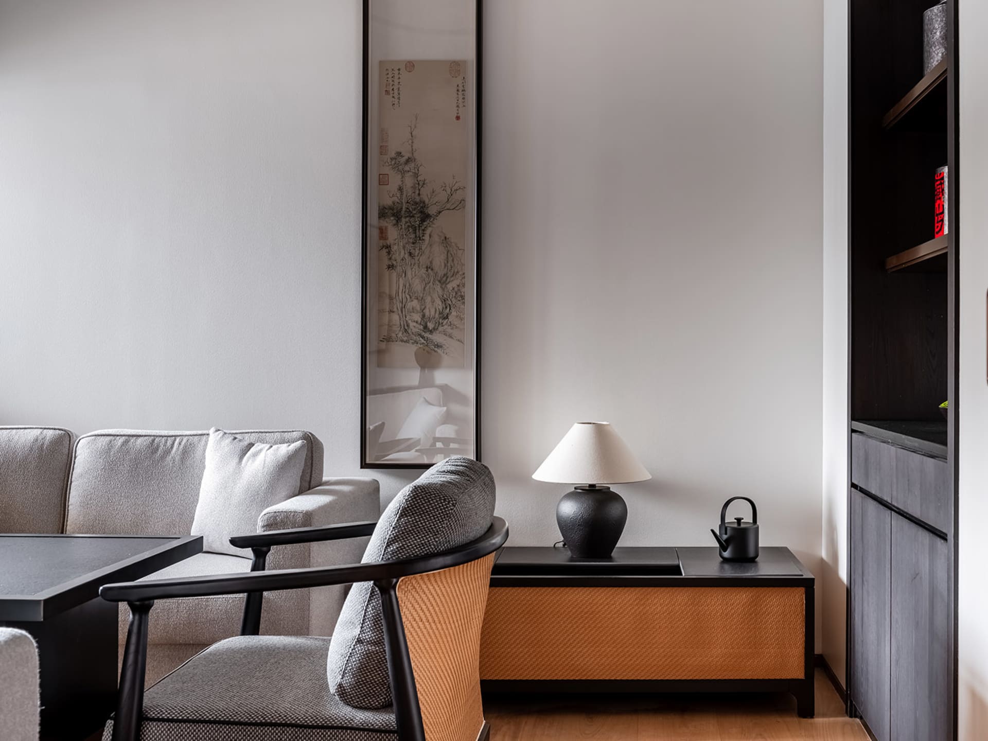 Cozy living room with artwork, two couches, chairs, and a dining table, creating a pleasant environment for relaxation and socializing