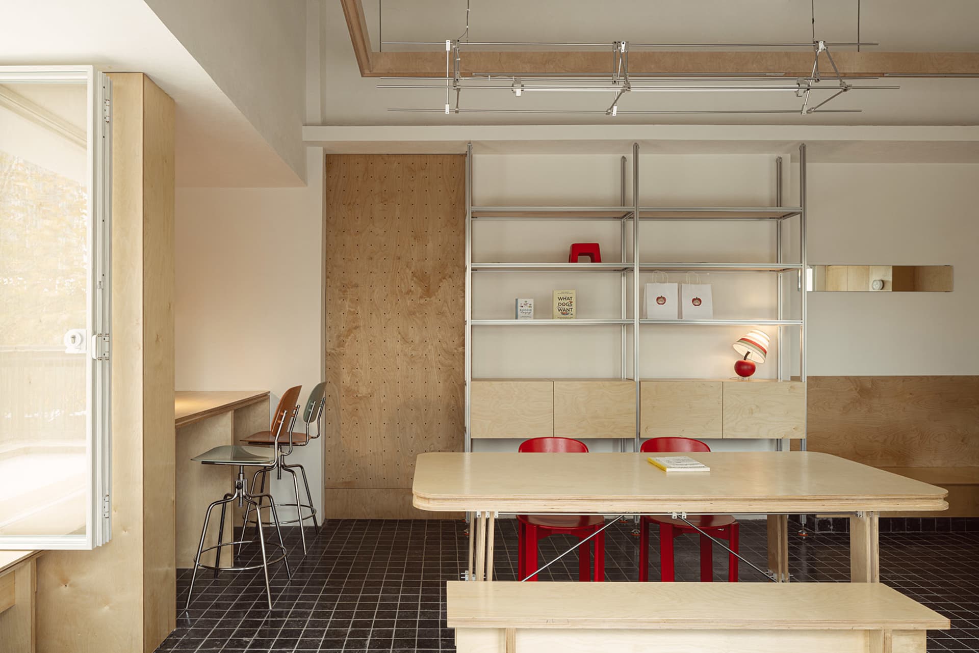 Open dining area with a wooden table and red chairs, suggesting a cozy and inviting atmosphere for gatherings and meals