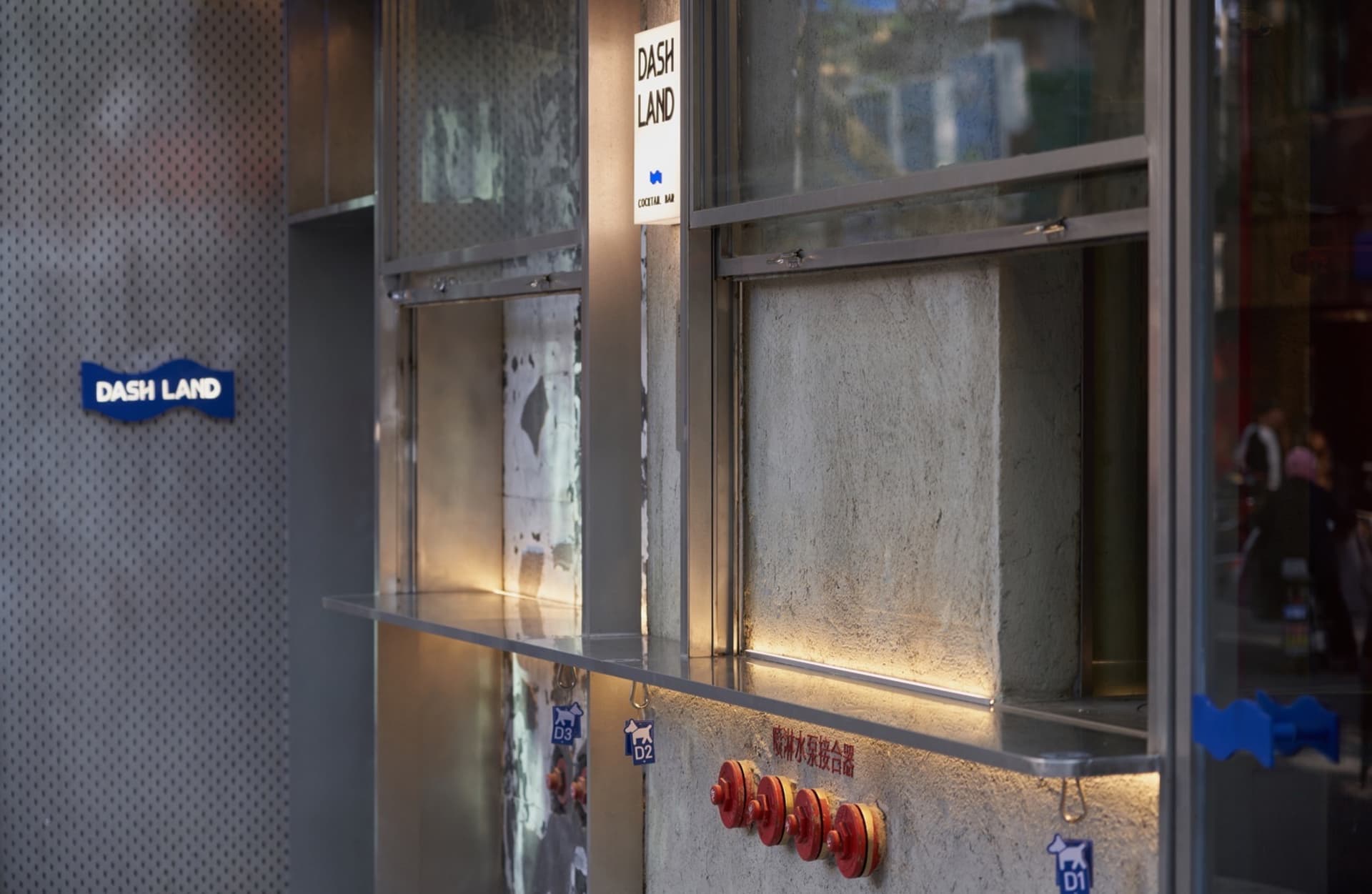 Industrial kitchen with a countertop featuring multiple red fire extinguishers and a utilitarian atmosphere