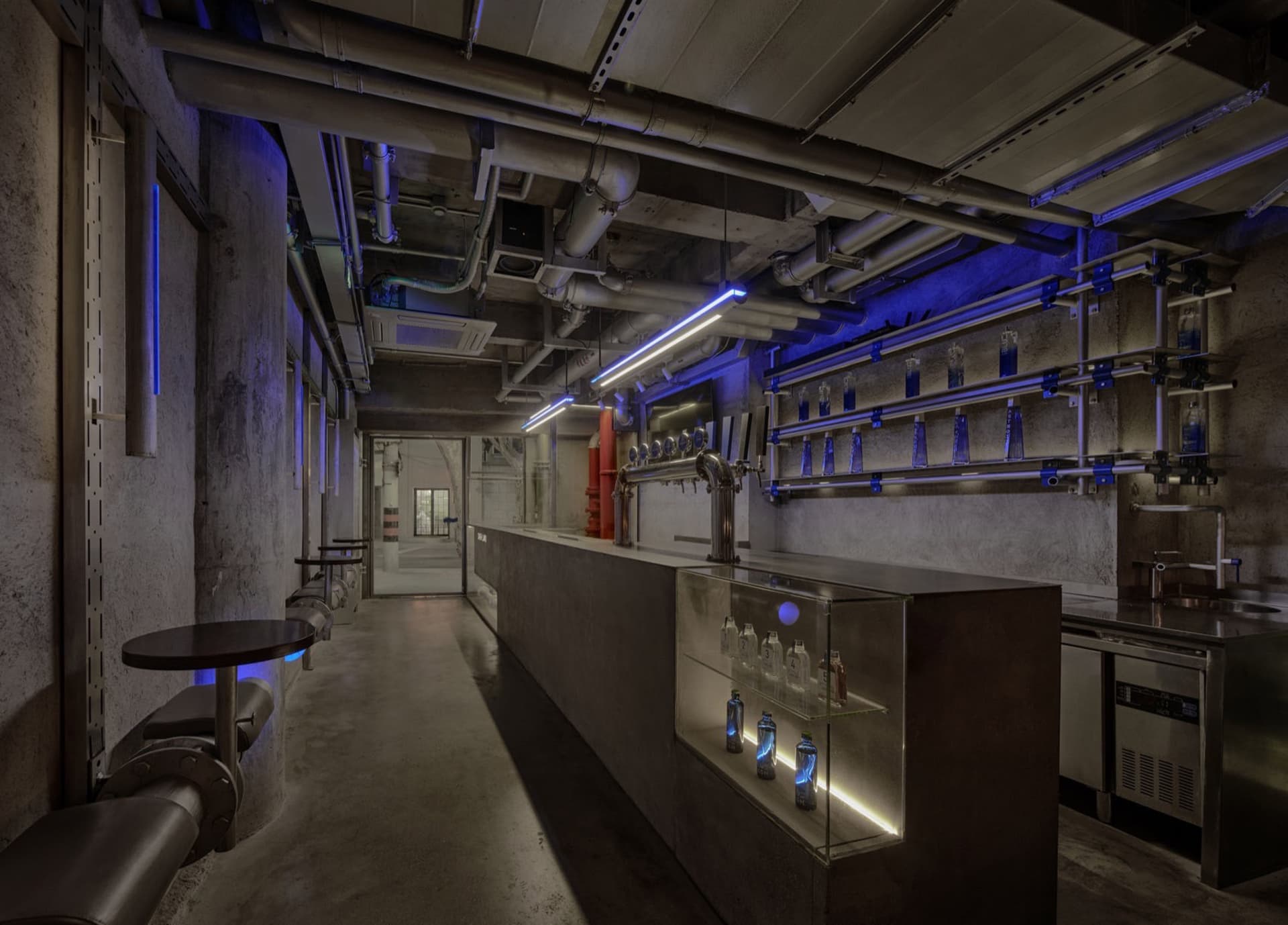 A well-stocked bar with a counter and chairs, creating an inviting atmosphere for socializing and enjoying drinks