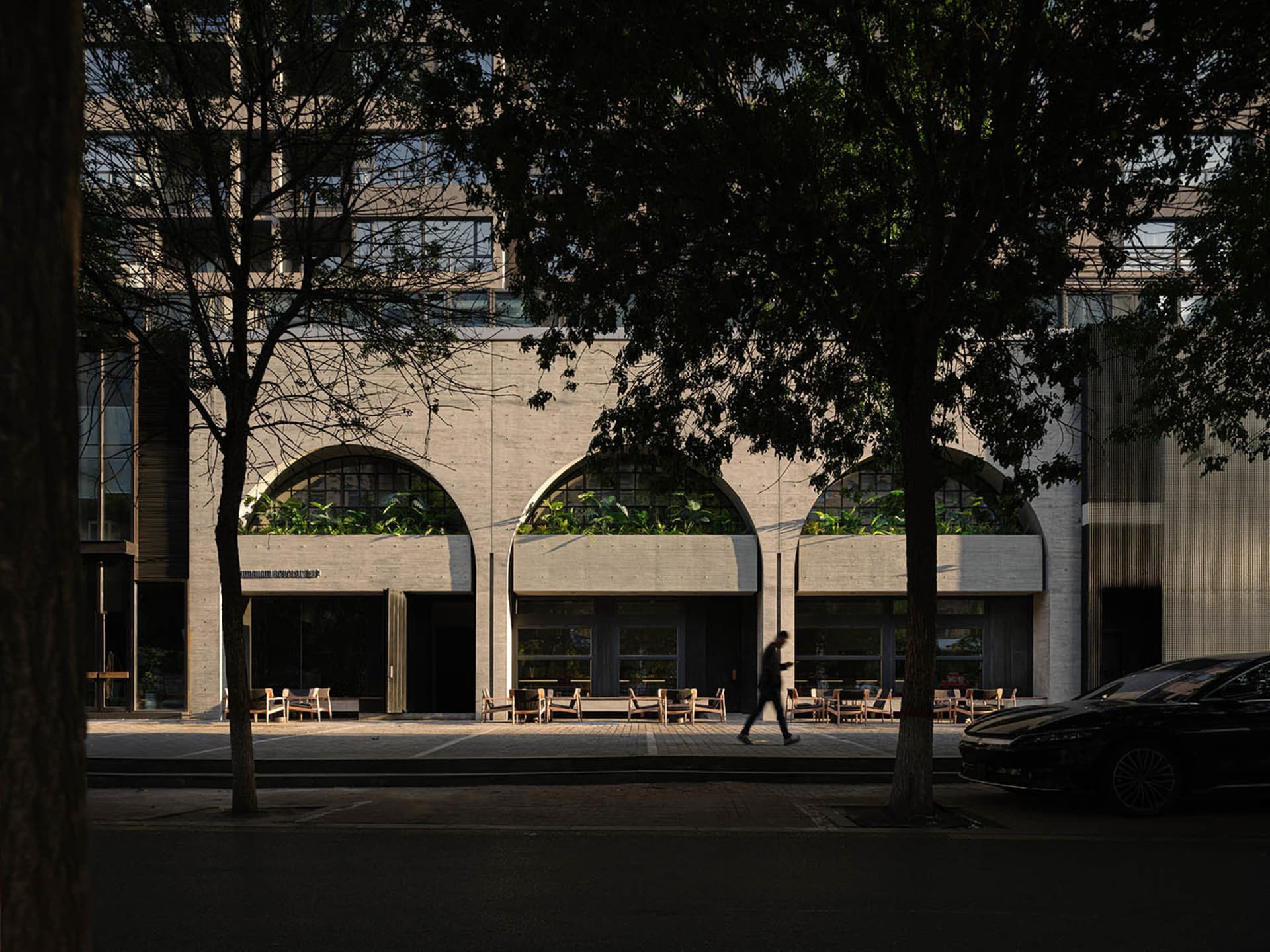 A calm and inviting urban street scene with benches and pedestrians