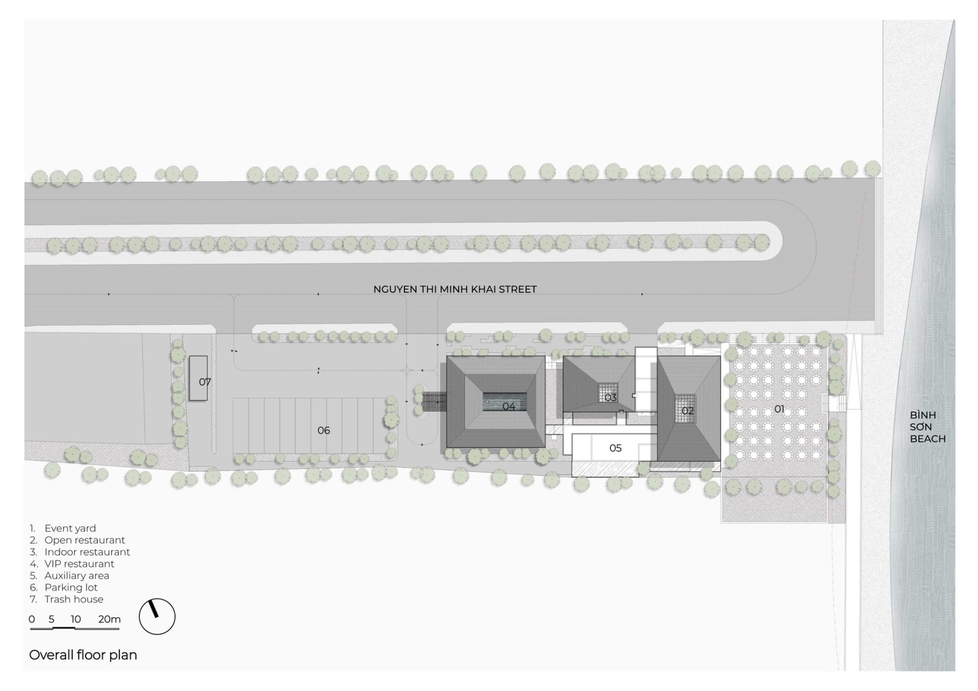Modern building with white exterior, garage area, and well-lit pedestrian-friendly street