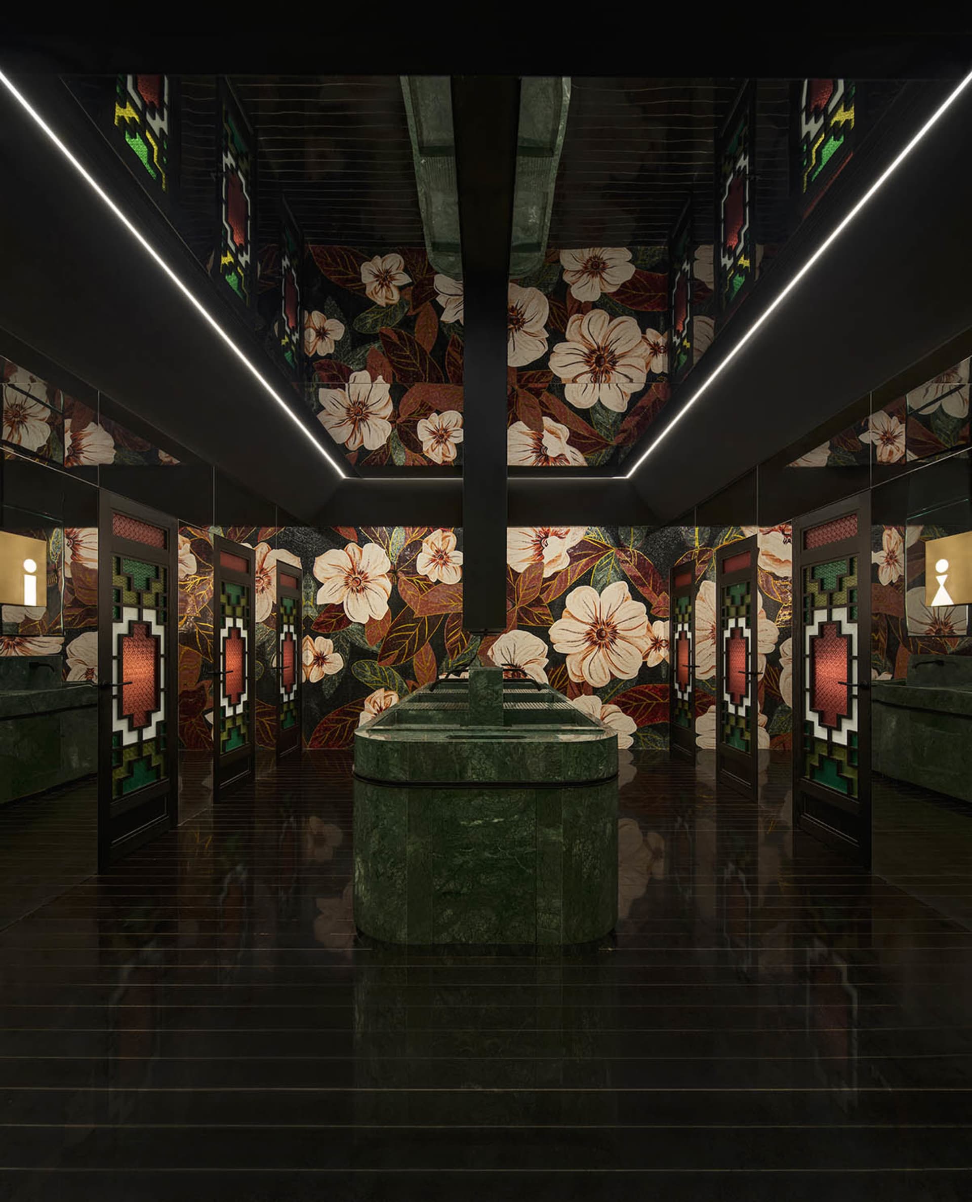 Ornate bathroom with a large stone sink and floral patterned walls, dimly lit for a cozy atmosphere