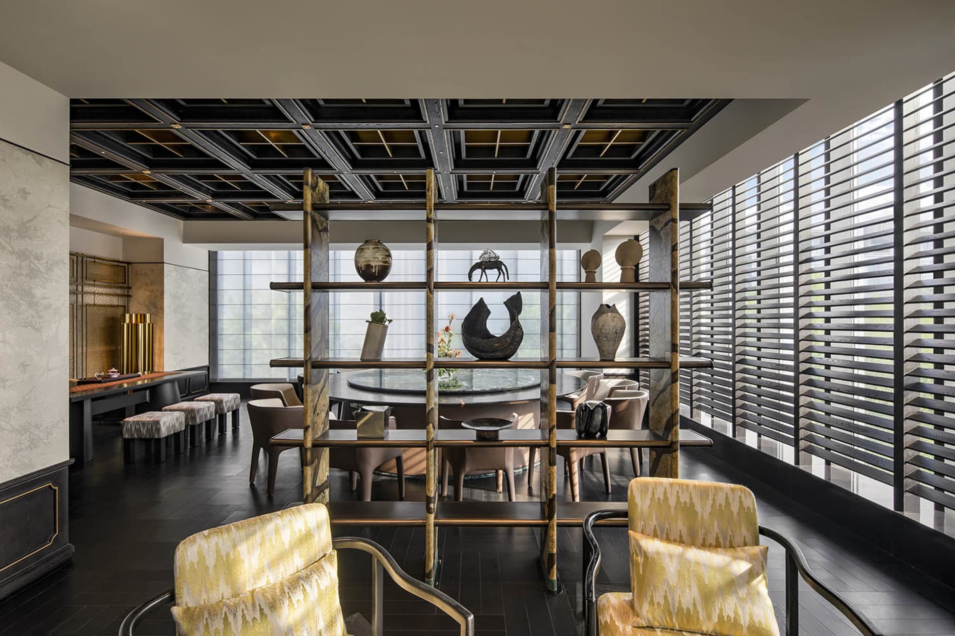 A well-lit dining area with multiple chairs, a dining table, and decorative vases on shelves, showcasing various styles and designs