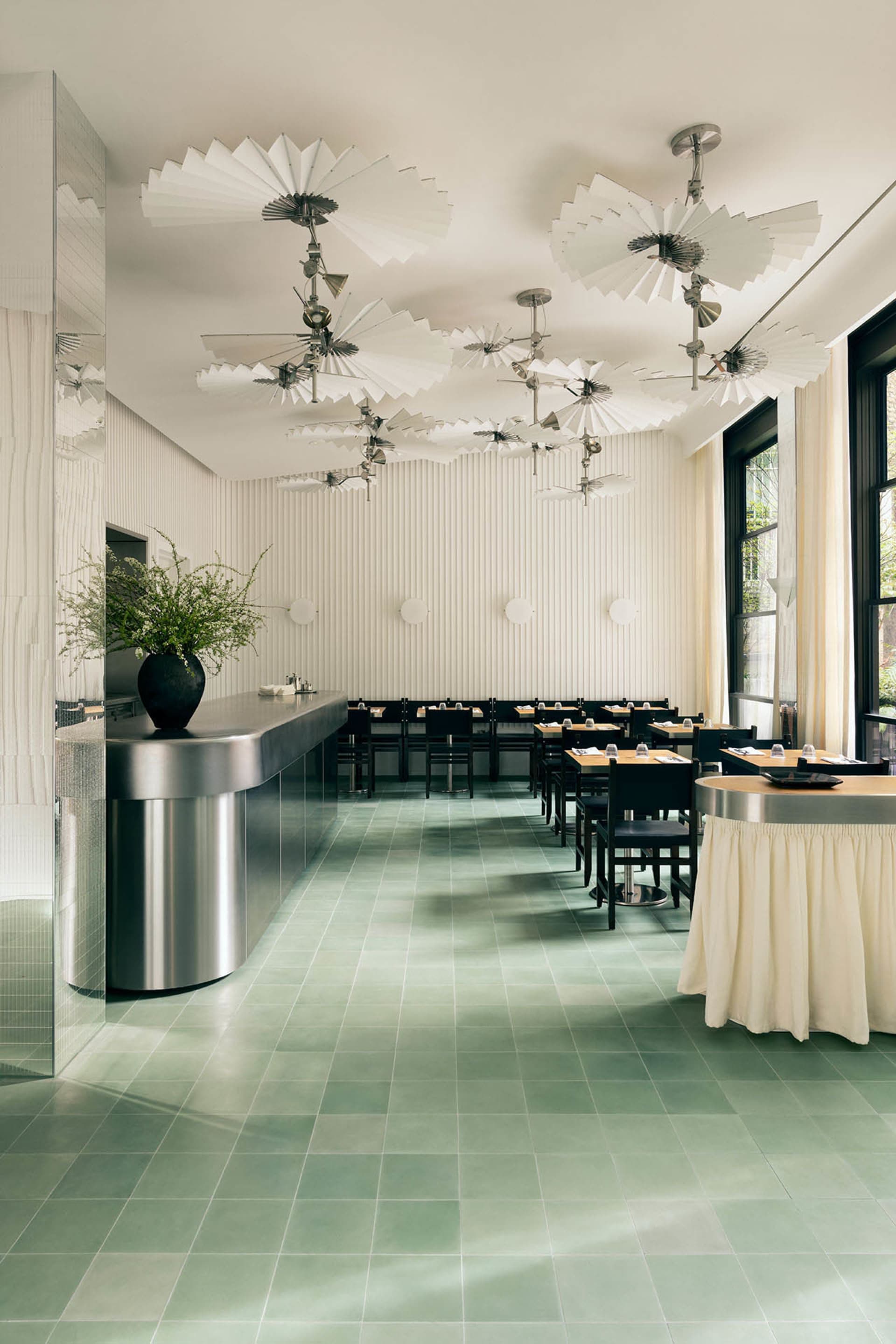 A clean and inviting restaurant dining area with multiple tables and chairs, varying in size and shape, set up for guests to enjoy their meals