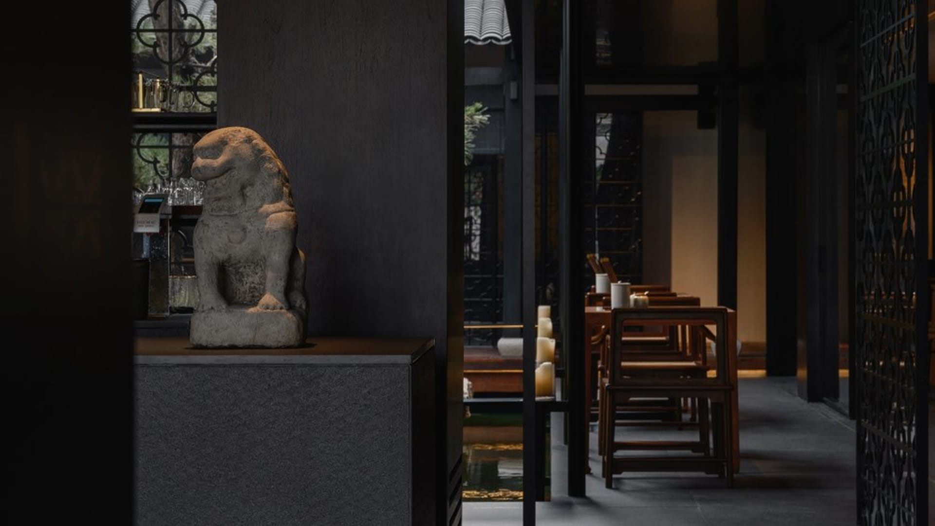 Sophisticated dining space with black and white color scheme, artwork on the walls, and a modern aesthetic