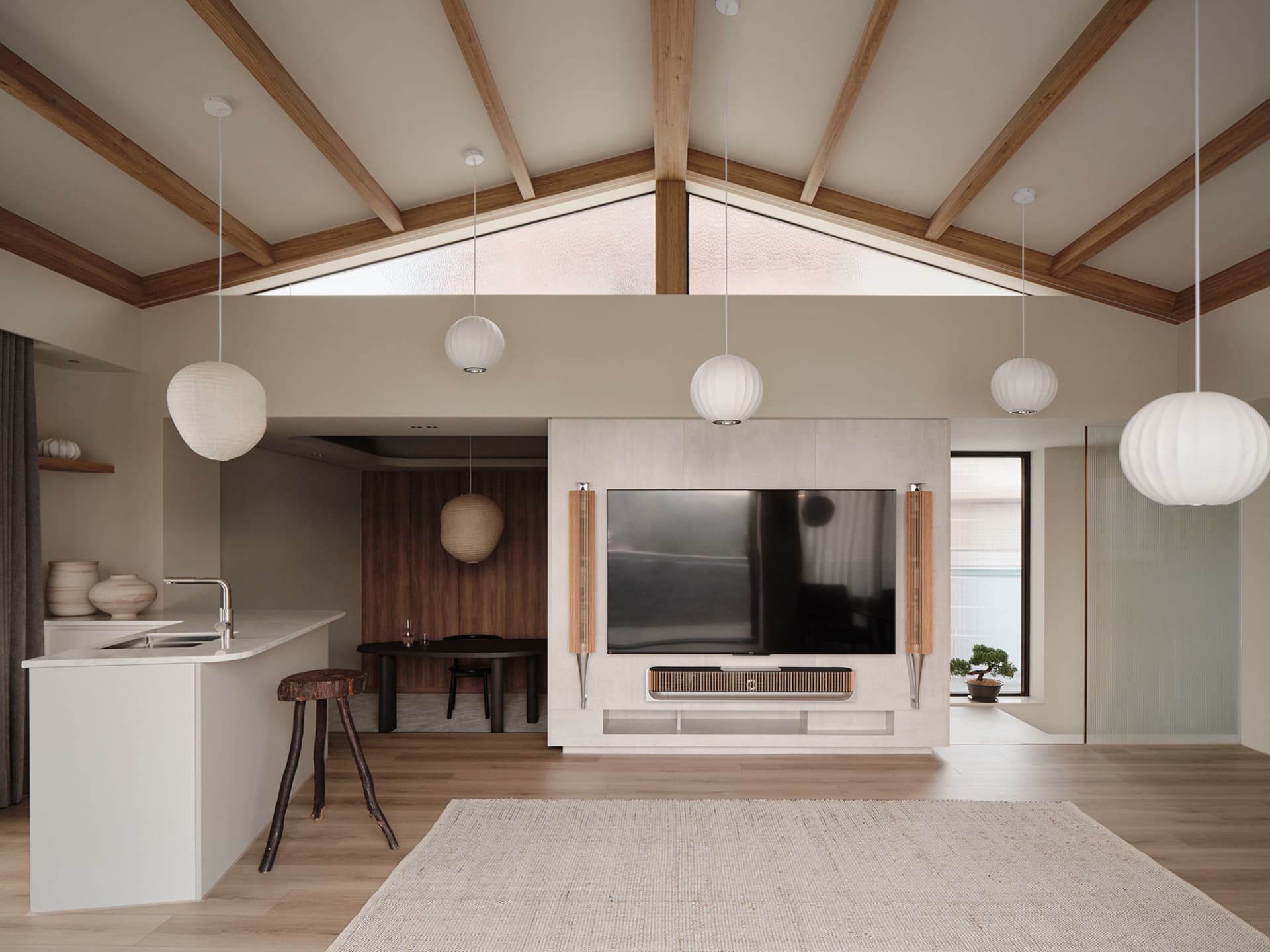 Open living area with a large TV, wooden floors, neutral tones, and potted plants