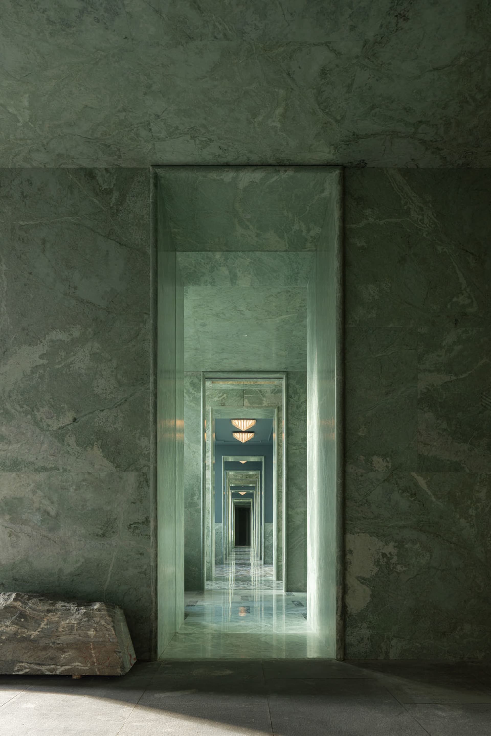 A large marble hallway with multiple mirrors reflecting the surroundings, creating a warm and sophisticated atmosphere