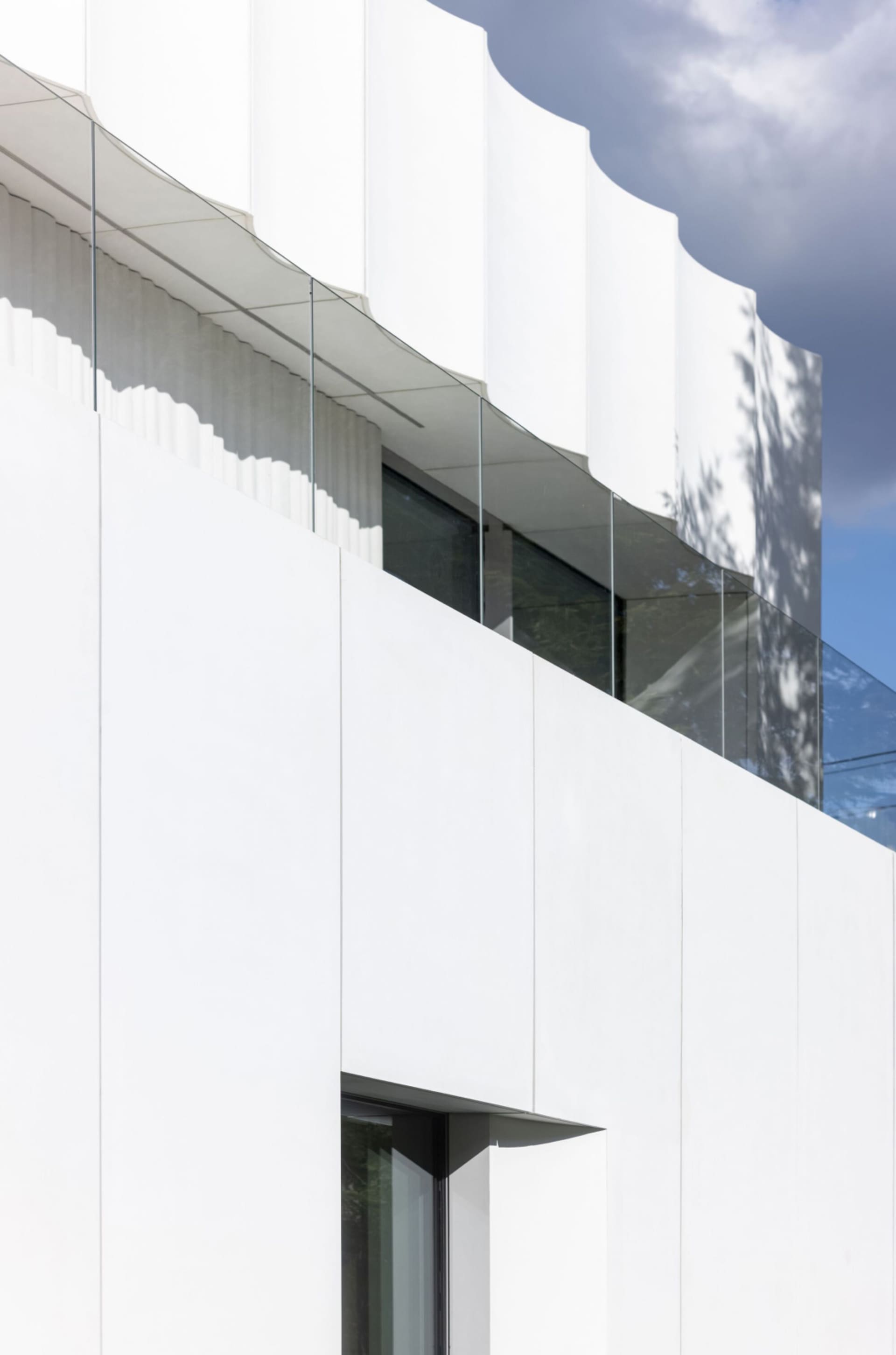 A modern office building with glass walls and large windows, flooded with natural light, conveying a sense of cleanliness and simplicity