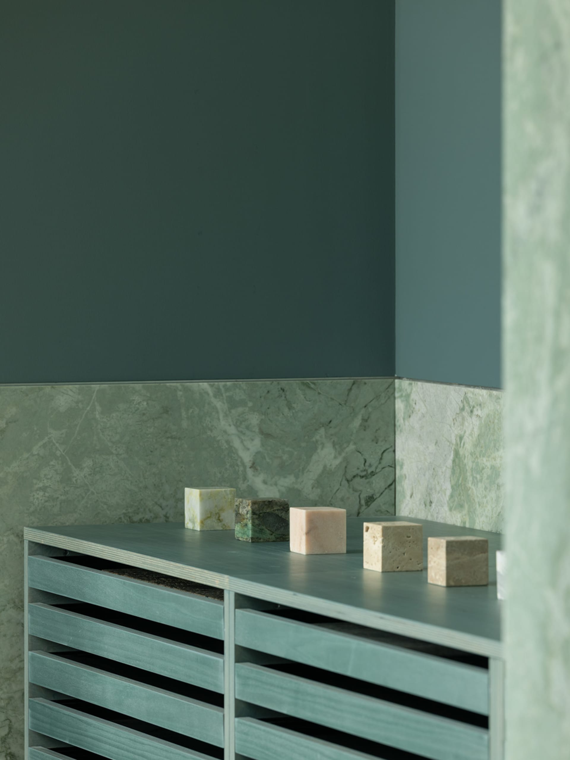 A clean bathroom with a countertop featuring decorative blocks and bottles, showcasing a focus on functionality and aesthetics
