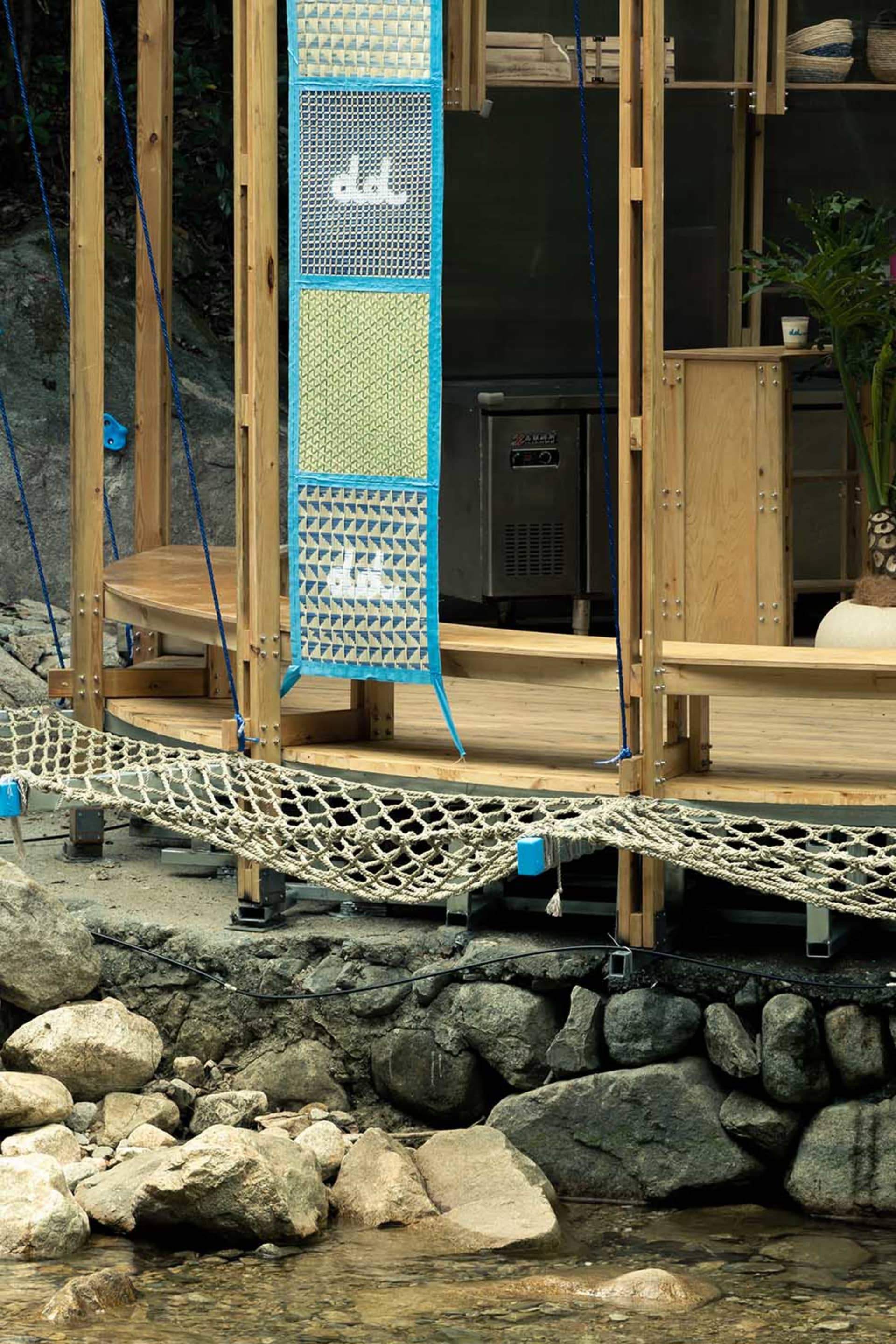 A serene outdoor space with a wooden deck, hammock, and two chairs, perfect for relaxation