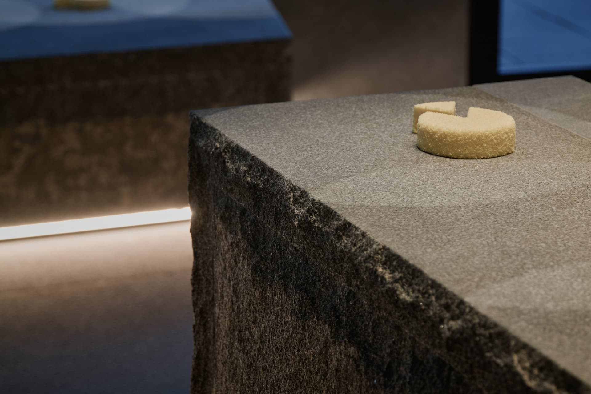 A kitchen countertop with a marble surface, featuring two cakes and a cozy atmosphere