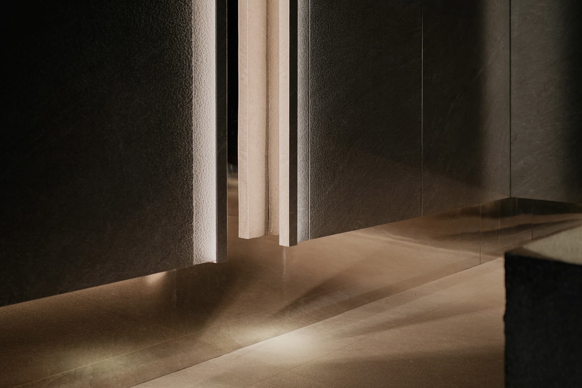 Modern bathroom with glass doors, marble walls, and a minimalist interior