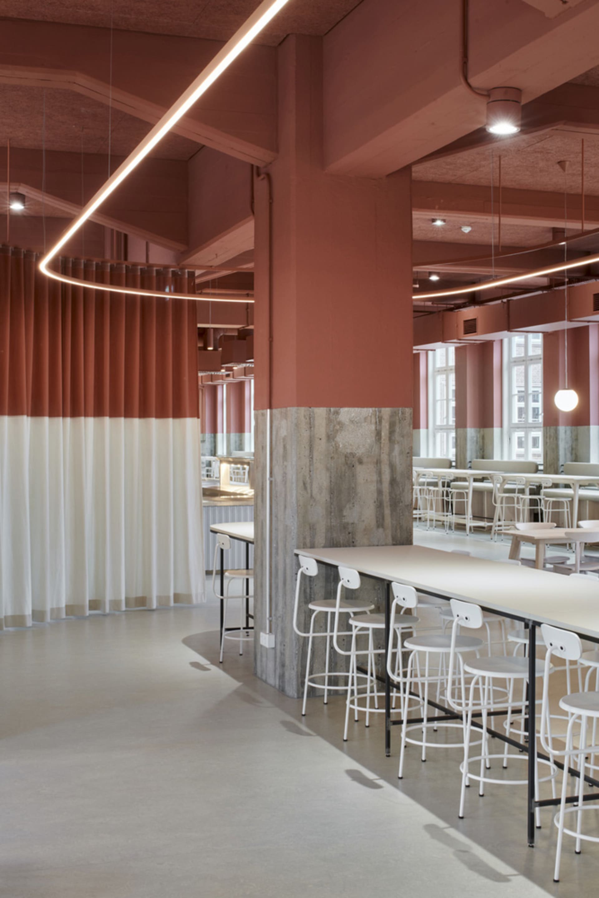 A restaurant-style dining space with a large table surrounded by multiple chairs, creating a warm and inviting atmosphere