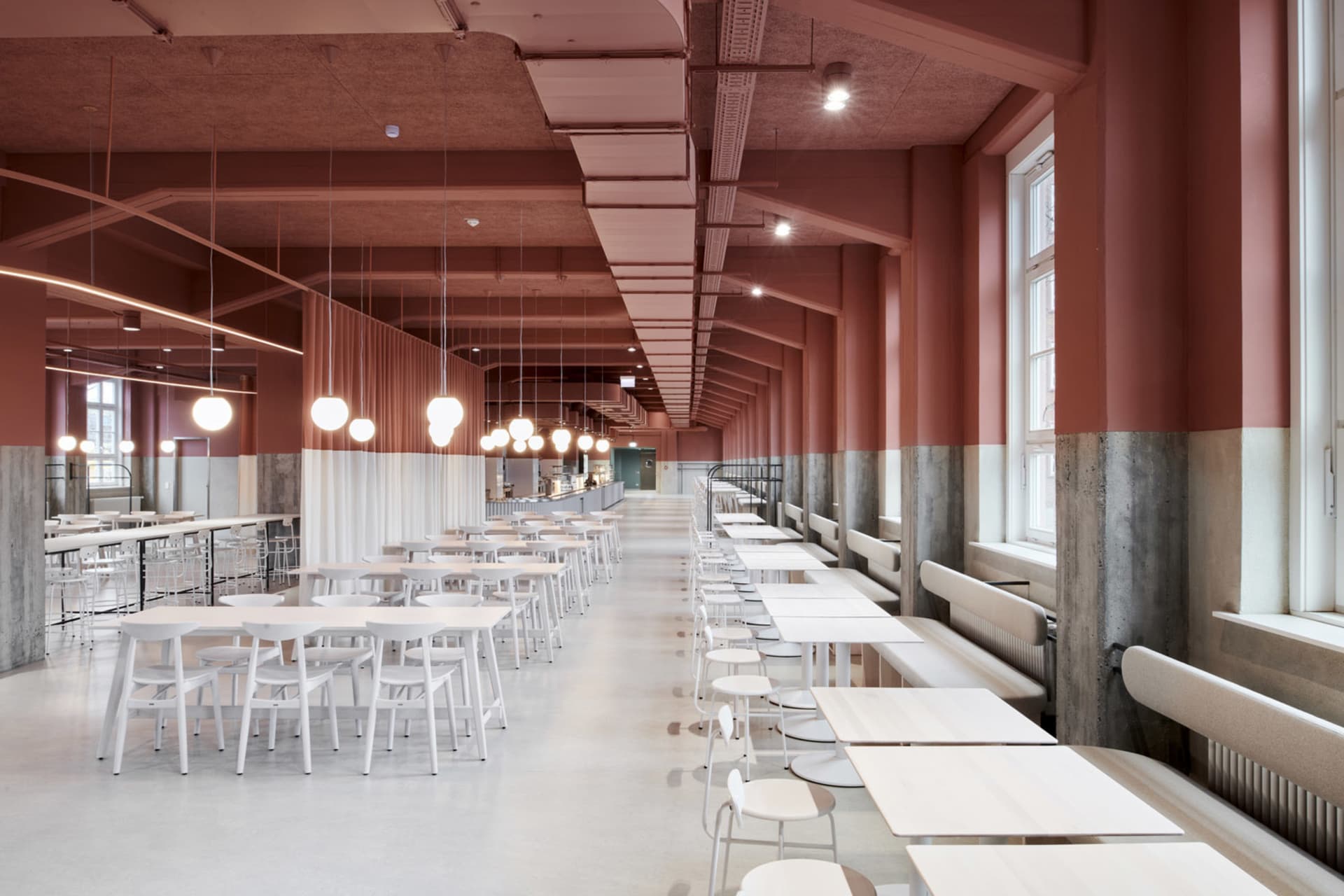 Modern dining area with white tables and chairs, well-lit and inviting