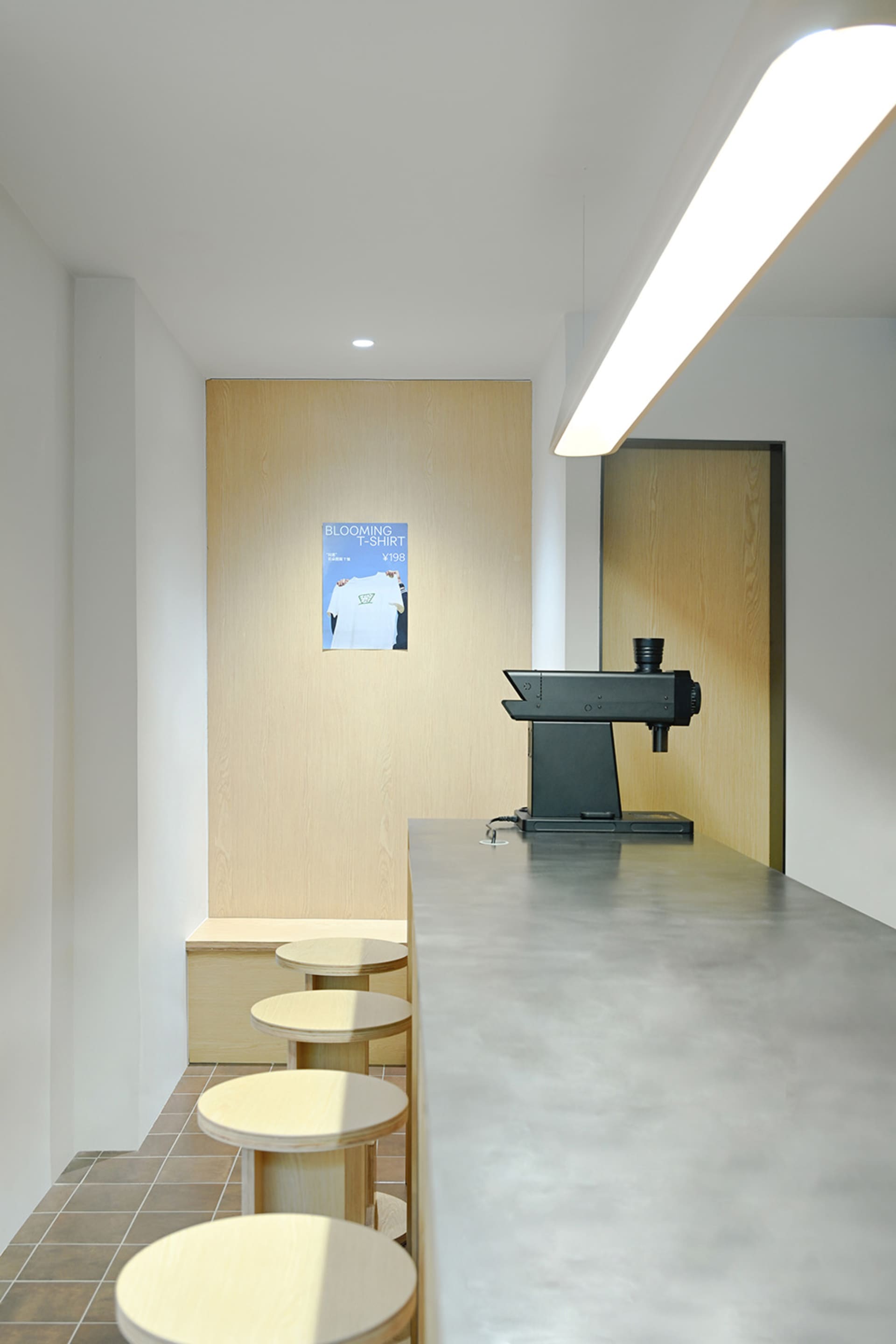 A casual dining space with a wooden counter, stools, and a coffee maker, set in a warm and inviting atmosphere