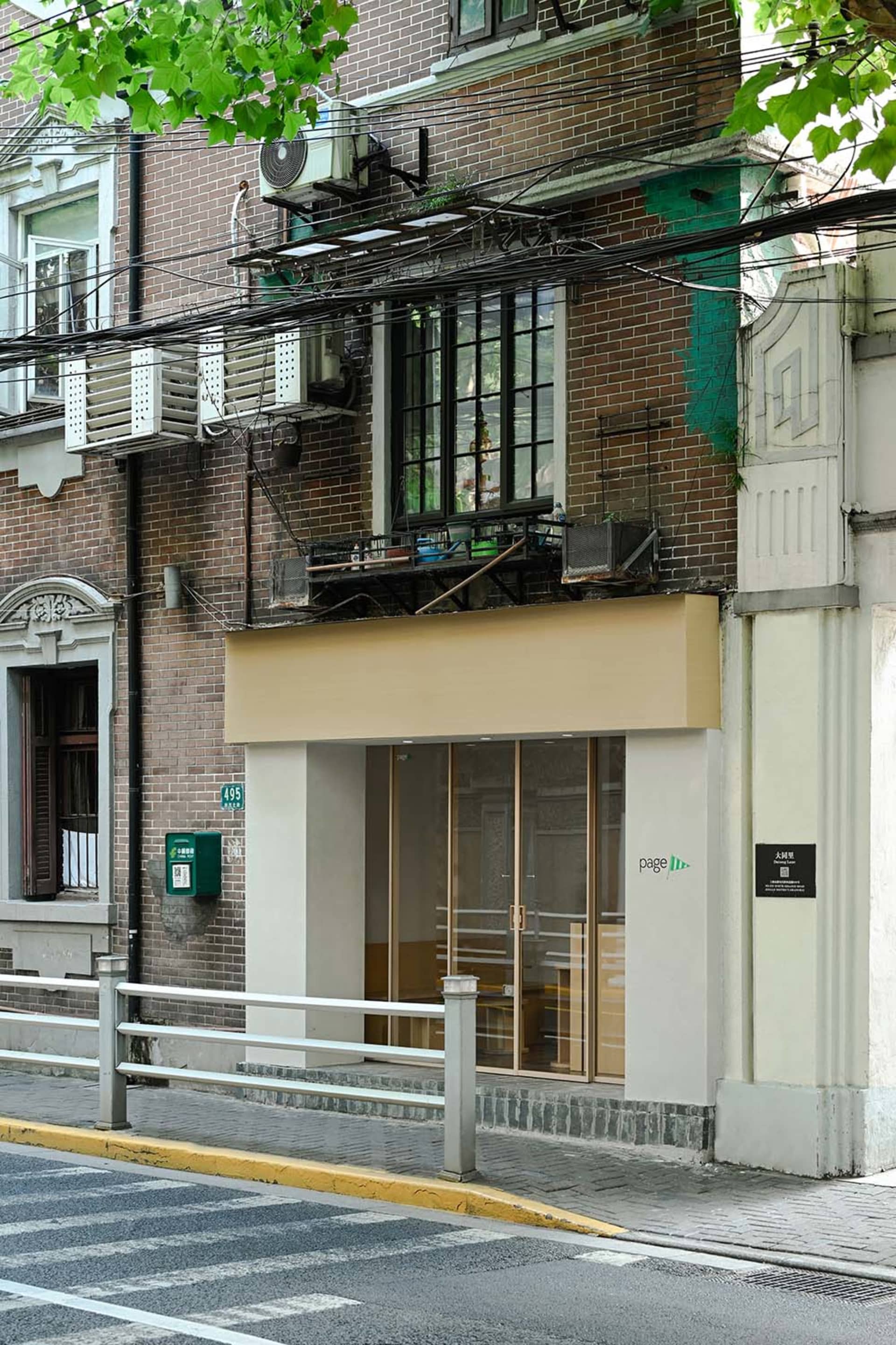 A brick building with a large window on its side, suggesting a bright and welcoming interior with ample natural light