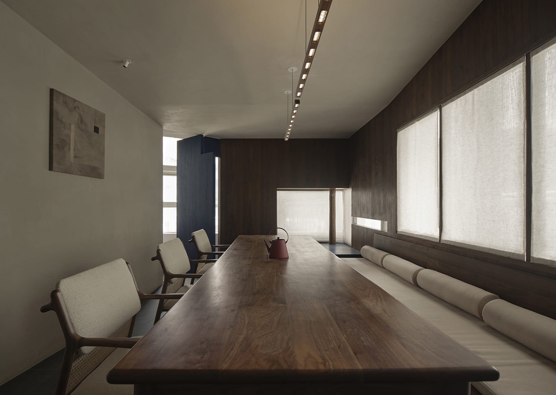 A well-lit dining area with a wooden table and chairs, creating a warm and elegant atmosphere