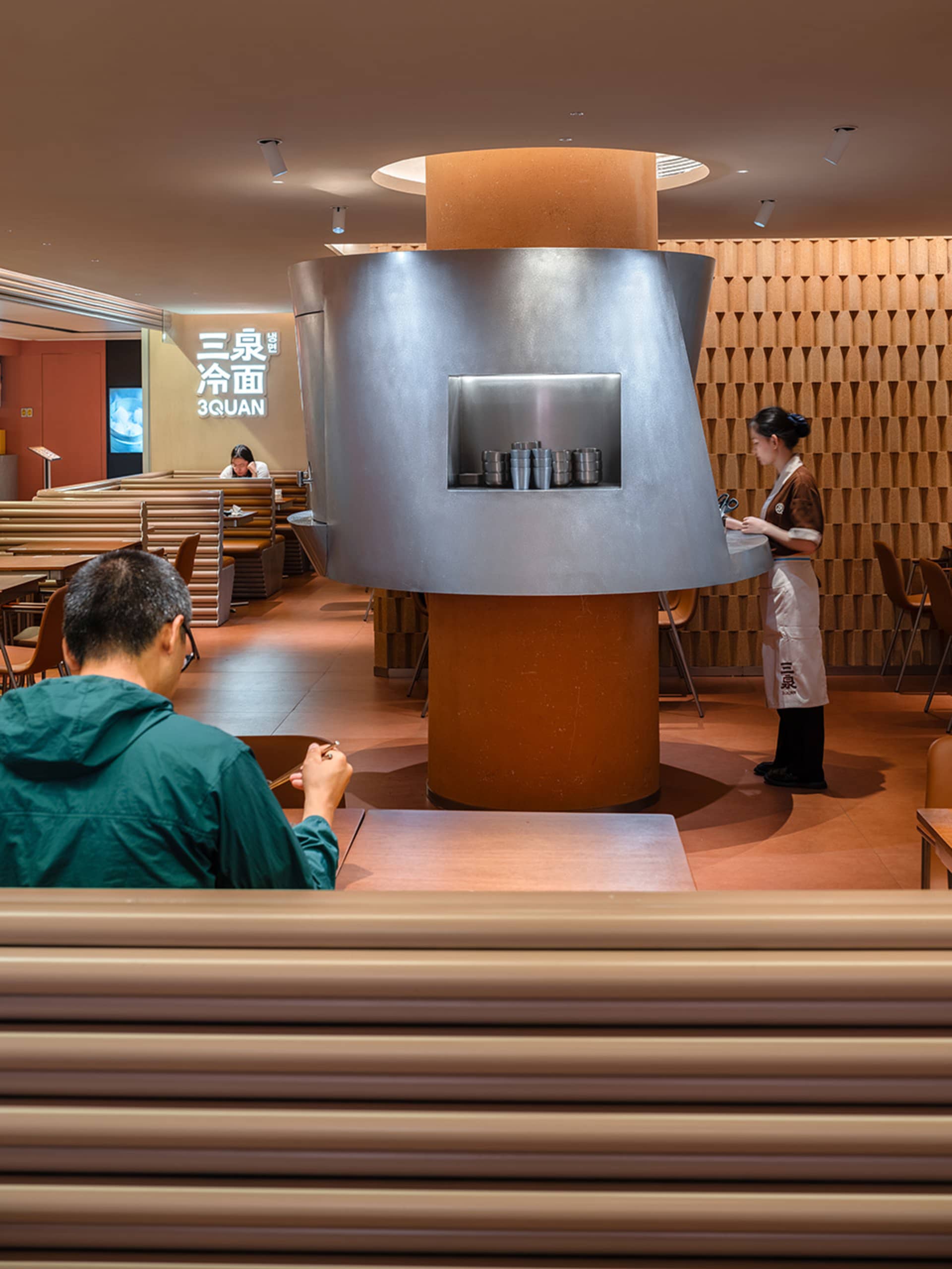 A modern Asian restaurant with dining tables, chairs, and wood paneling, creating a warm and inviting atmosphere