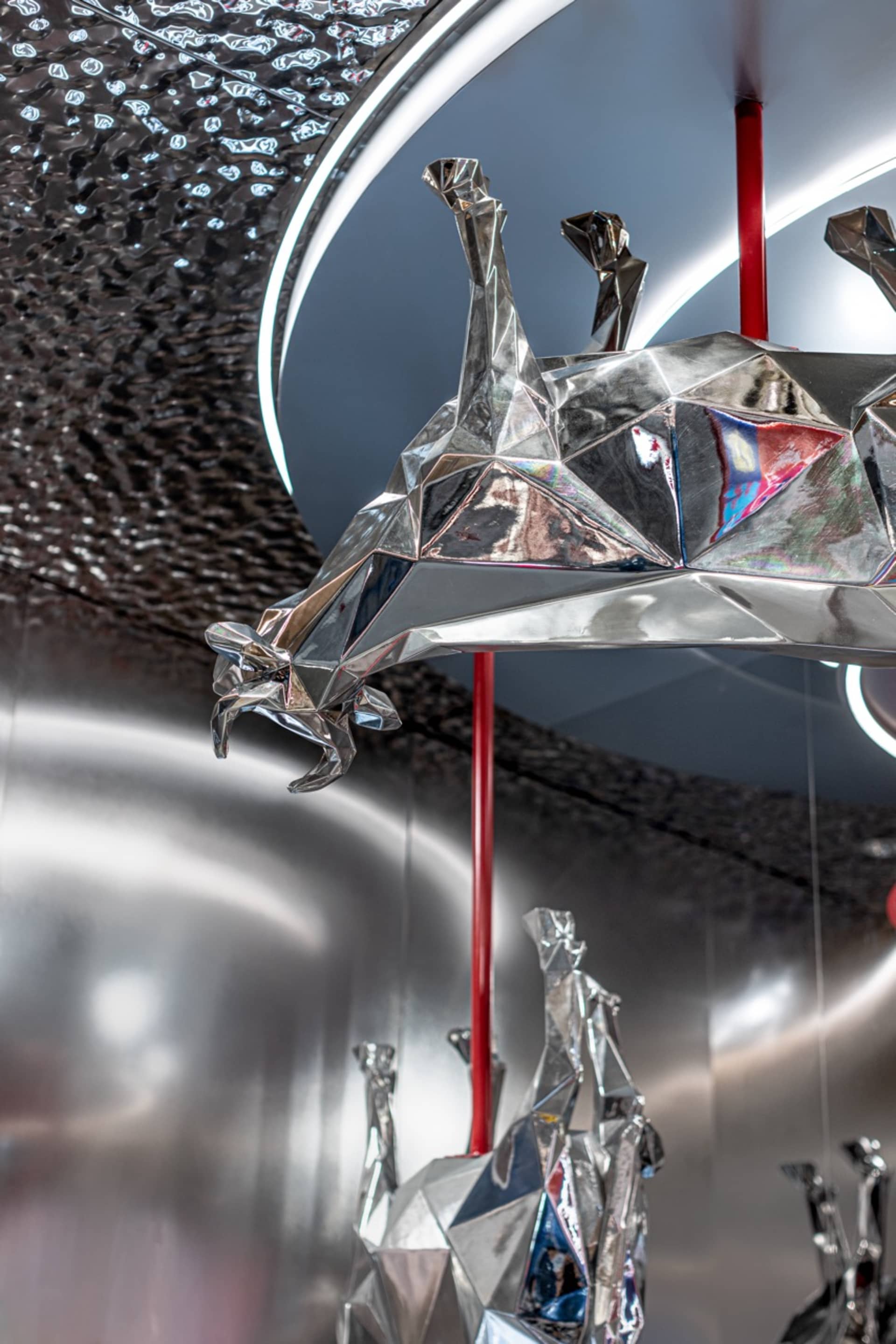 A room with various metal animal sculptures on the walls, creating a creative and visually engaging atmosphere