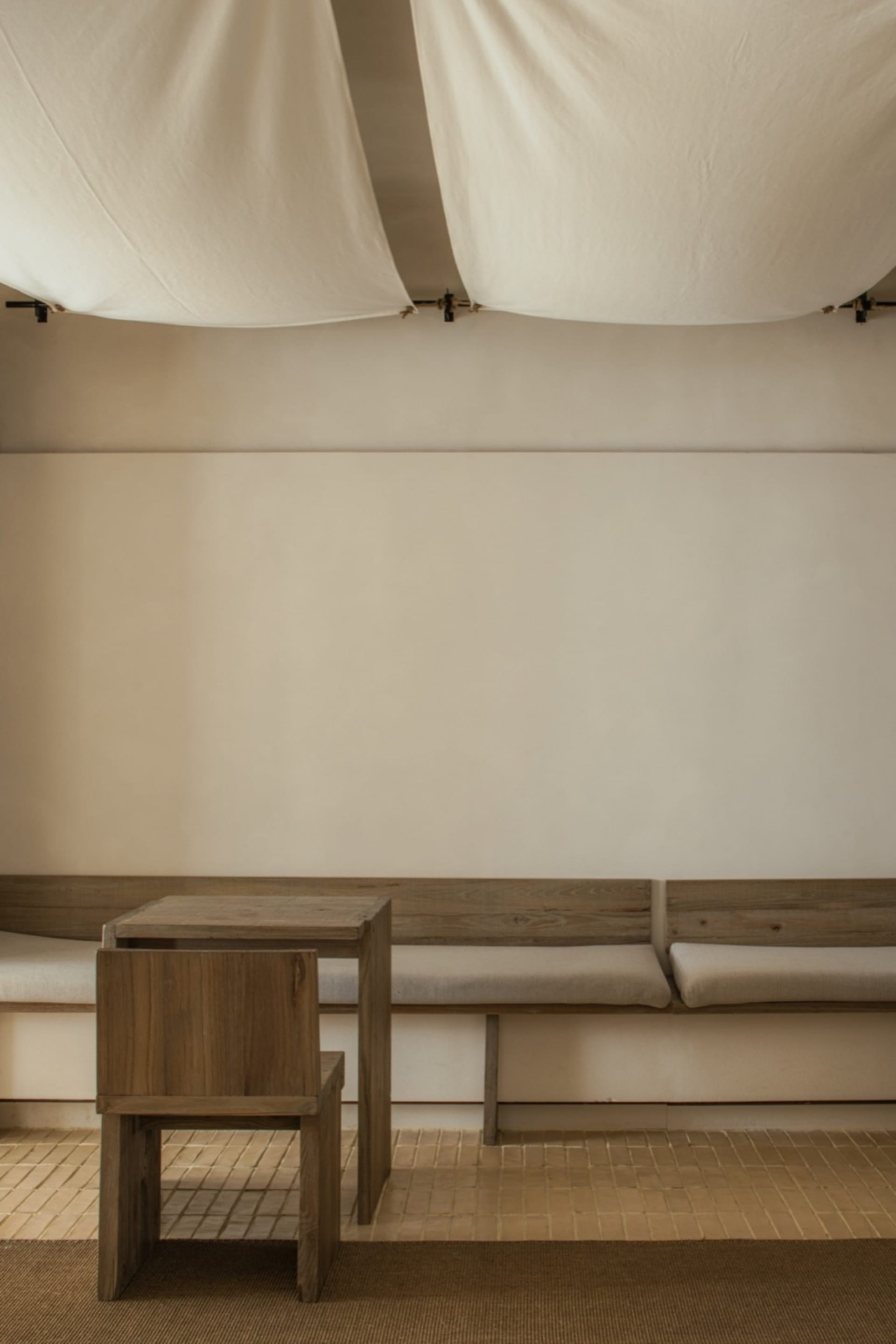 Empty living area with wooden benches and tables, calm and inviting atmosphere