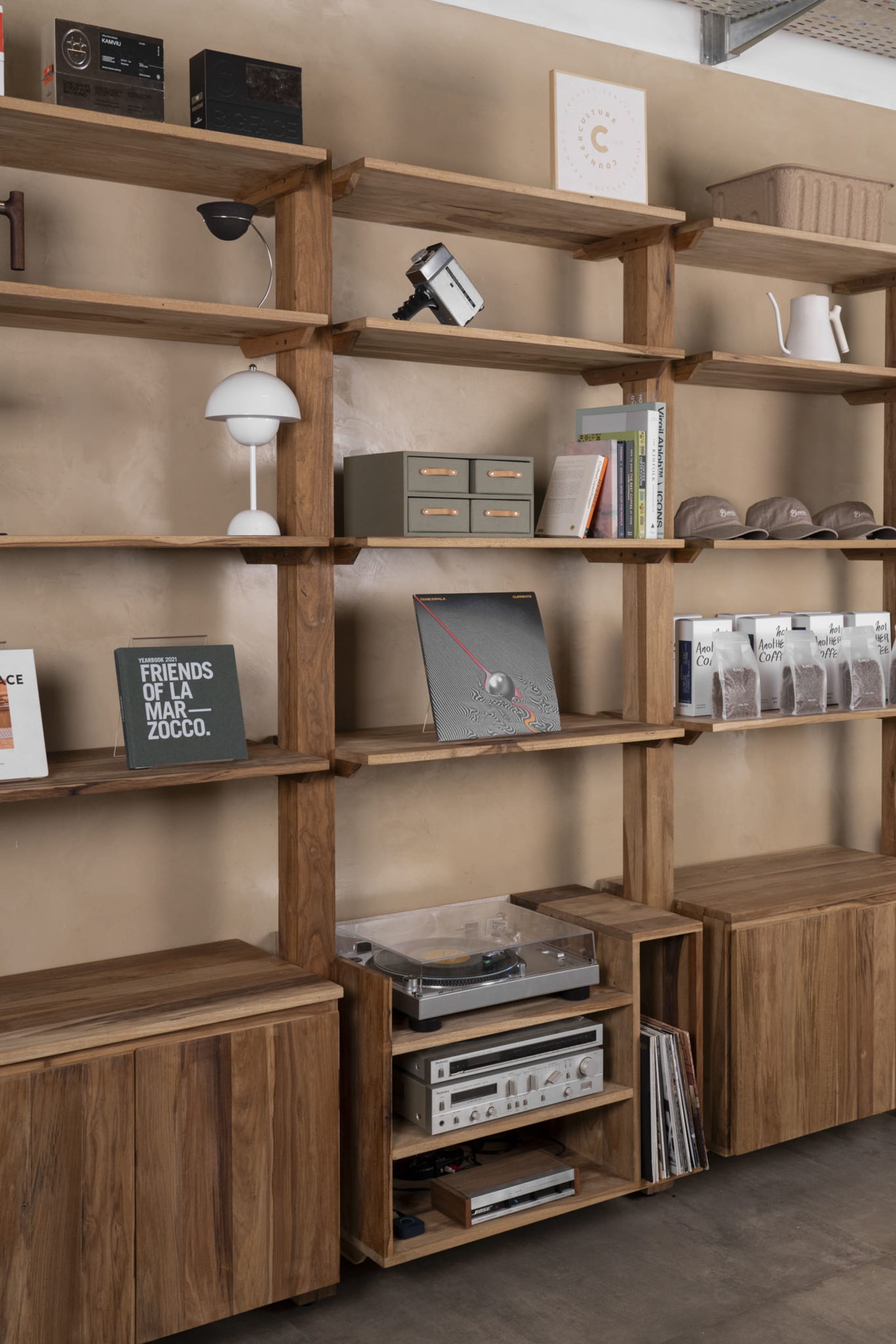A well-organized bookshelf with books and a record player, creating a cozy atmosphere for reading and listening to music