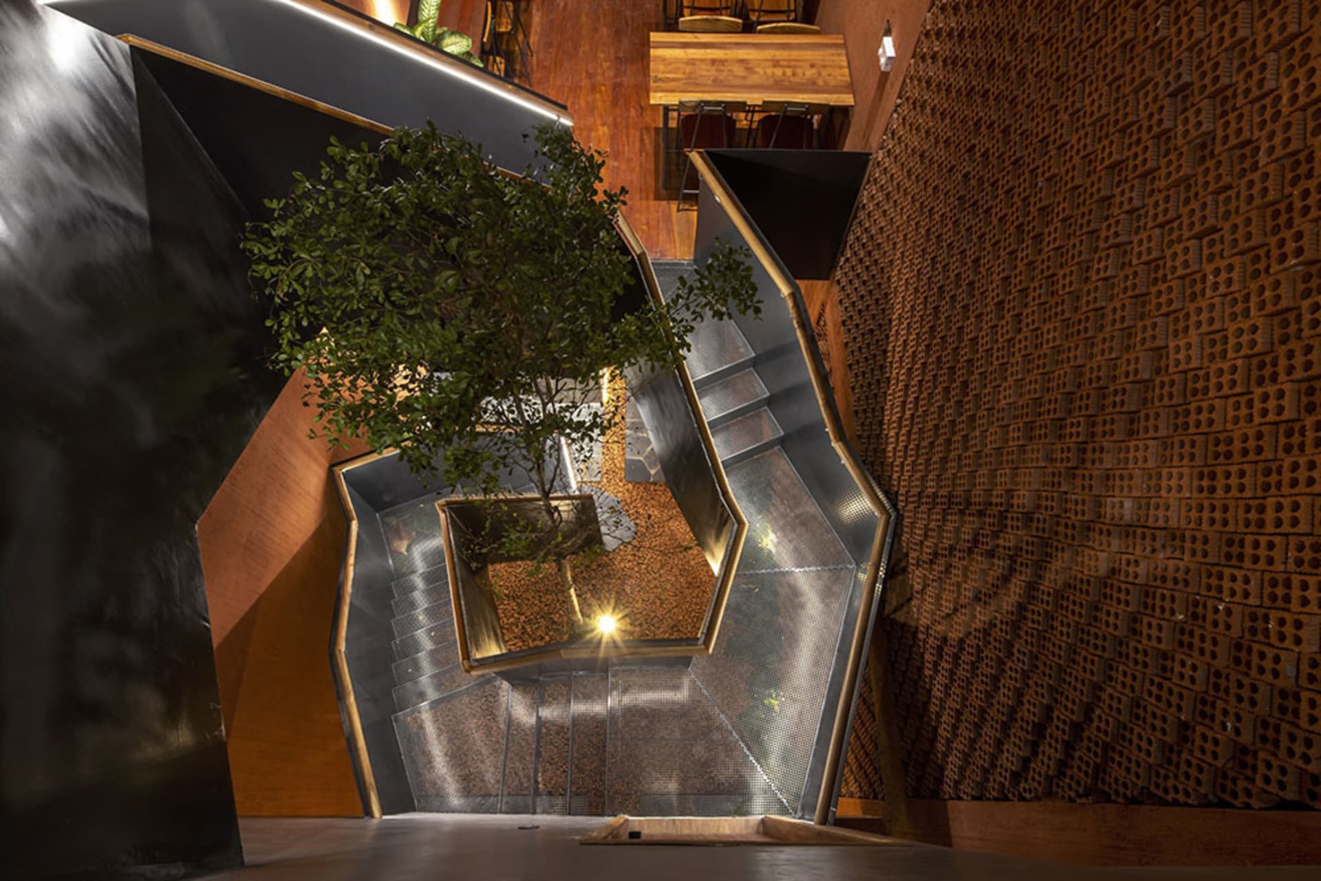 A modern building with multiple levels, stairs, and trees, featuring a well-designed and functional space