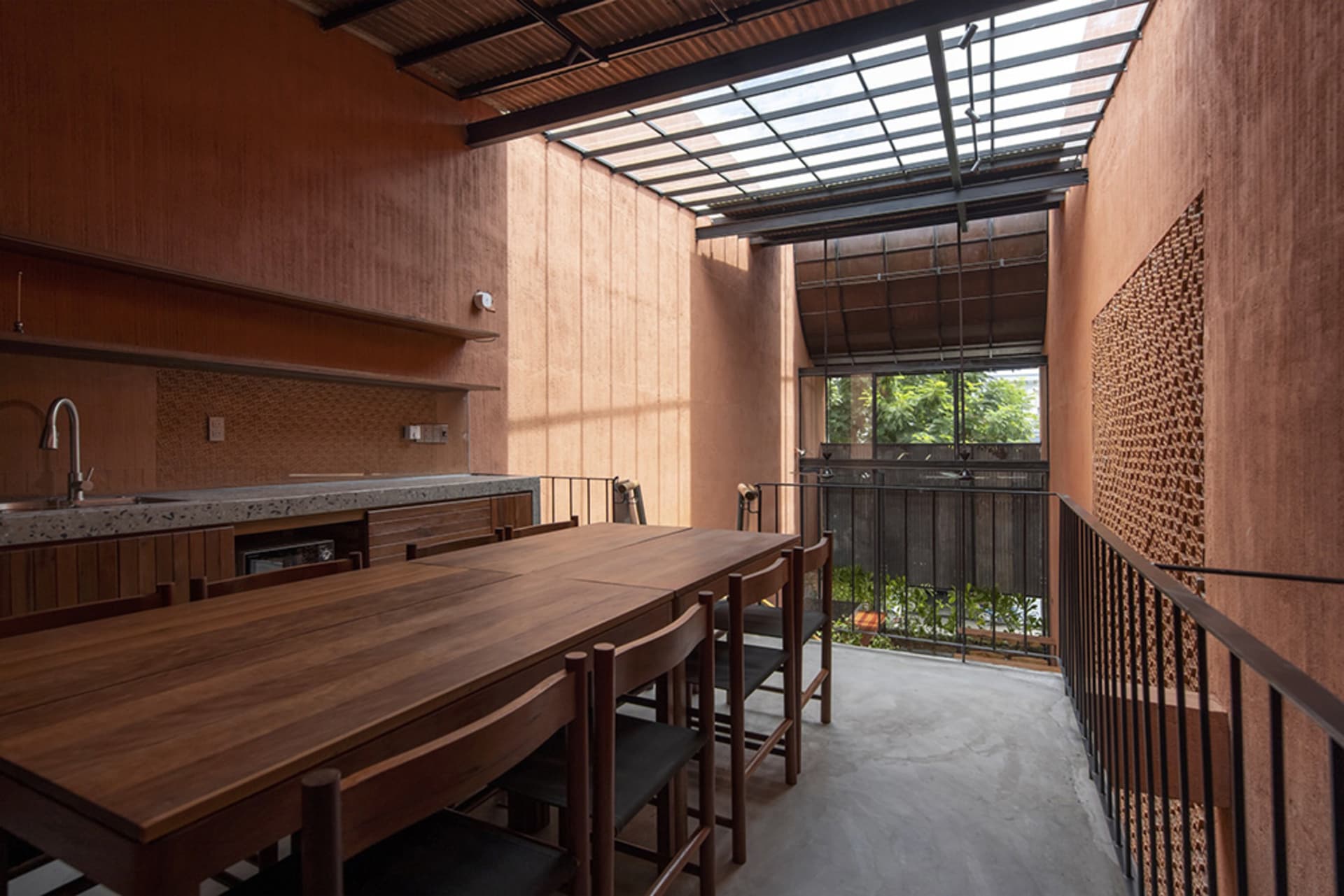 Warm and inviting open concept kitchen and dining area with a wooden table and chairs, surrounded by a larger living space