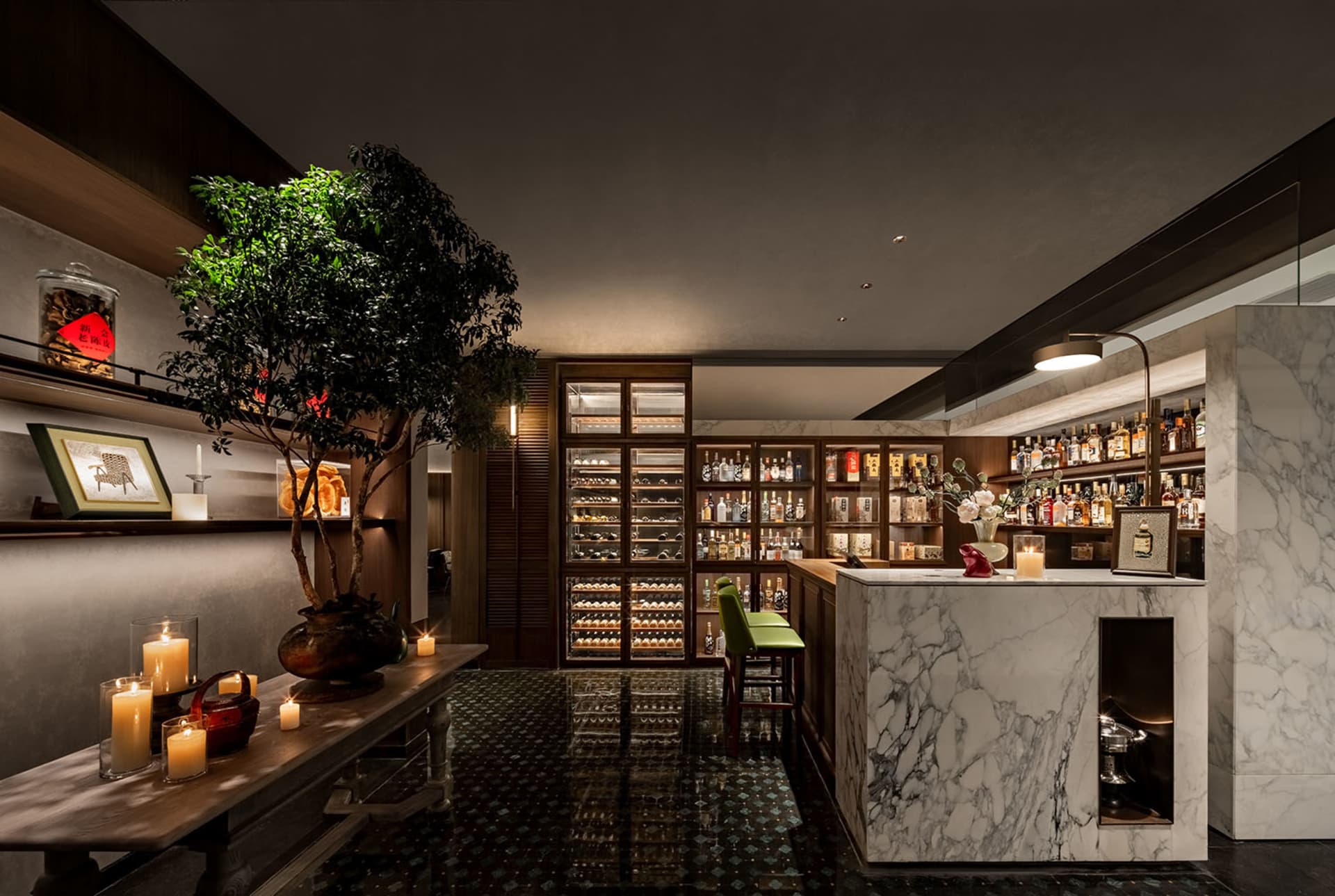 Elegant bar area with a marble countertop, comfortable seating, and upscale ambiance