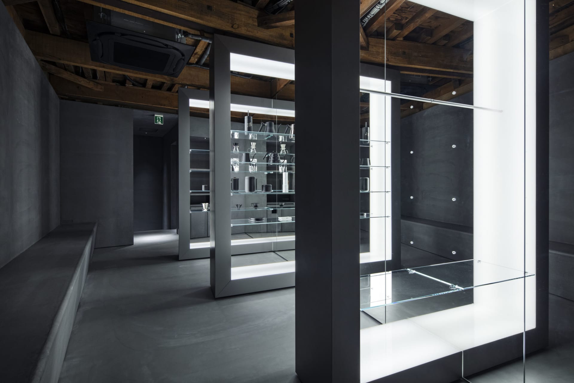 Empty bathroom with a large mirror on one wall, reflecting the surrounding area and creating a sense of depth