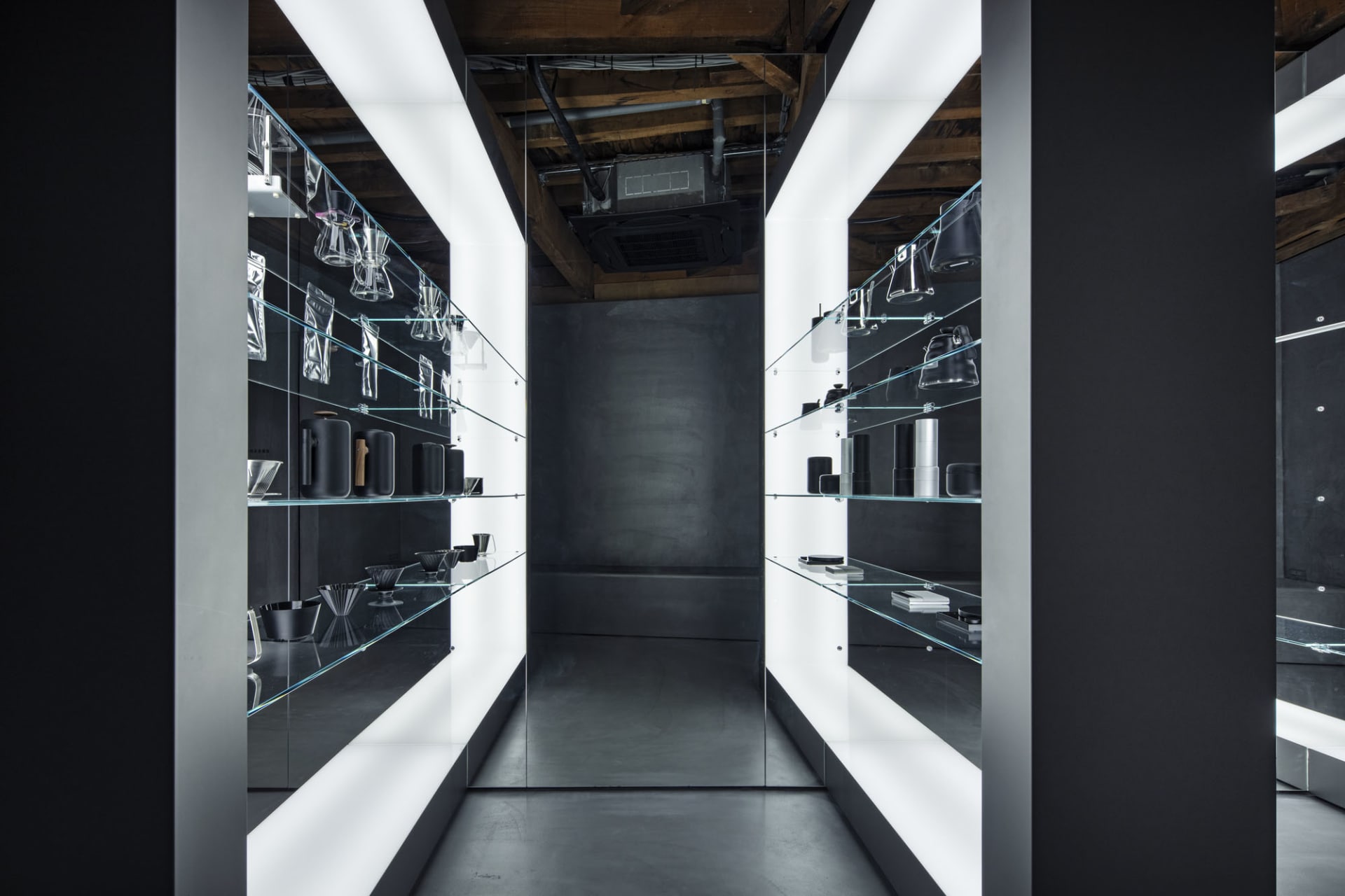 A modern store with glass display cases, shelves, and neutral tones, creating a clean and inviting atmosphere
