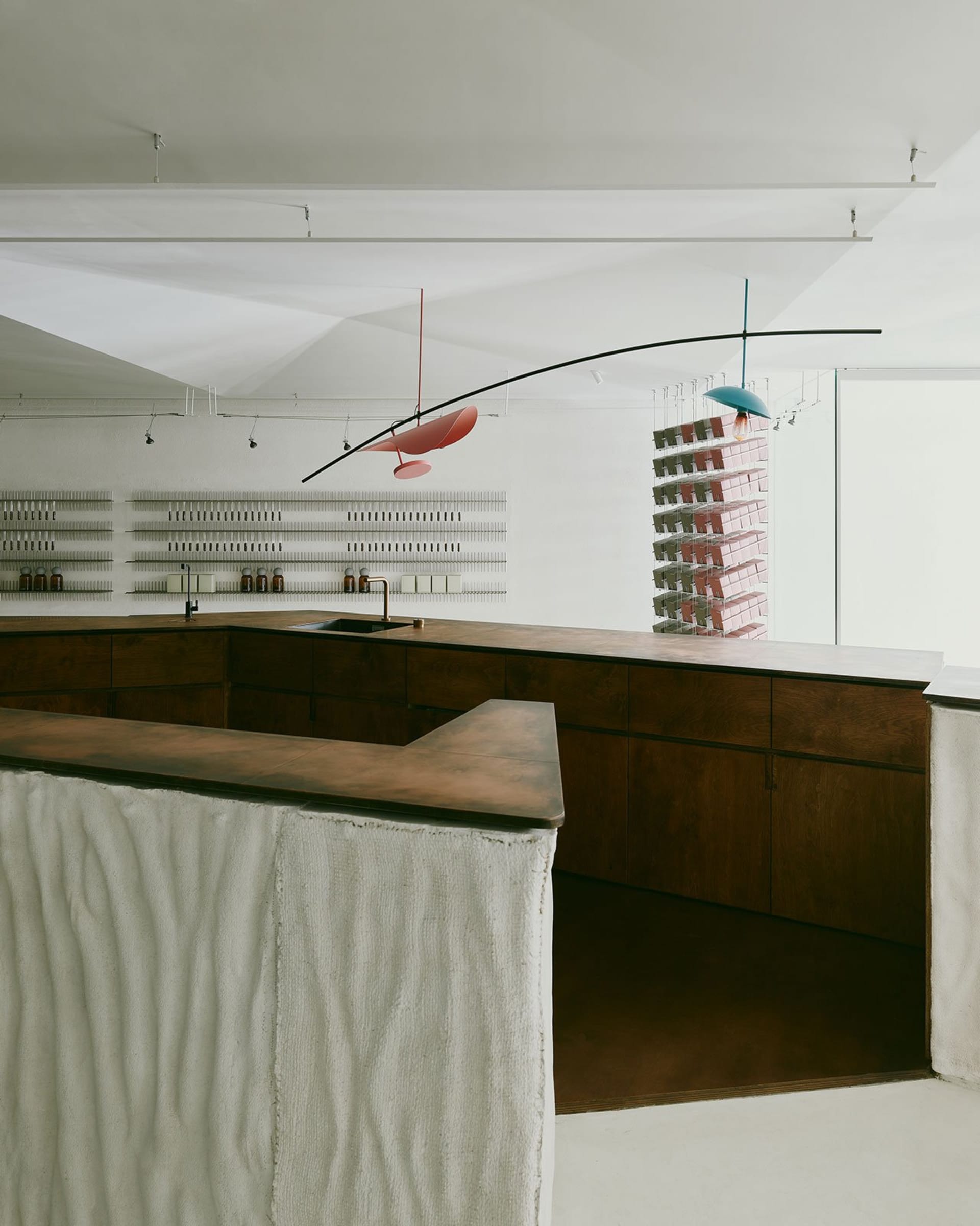 A modern retail space with glass counters, scattered books, and decorative vases, set in a stylish environment