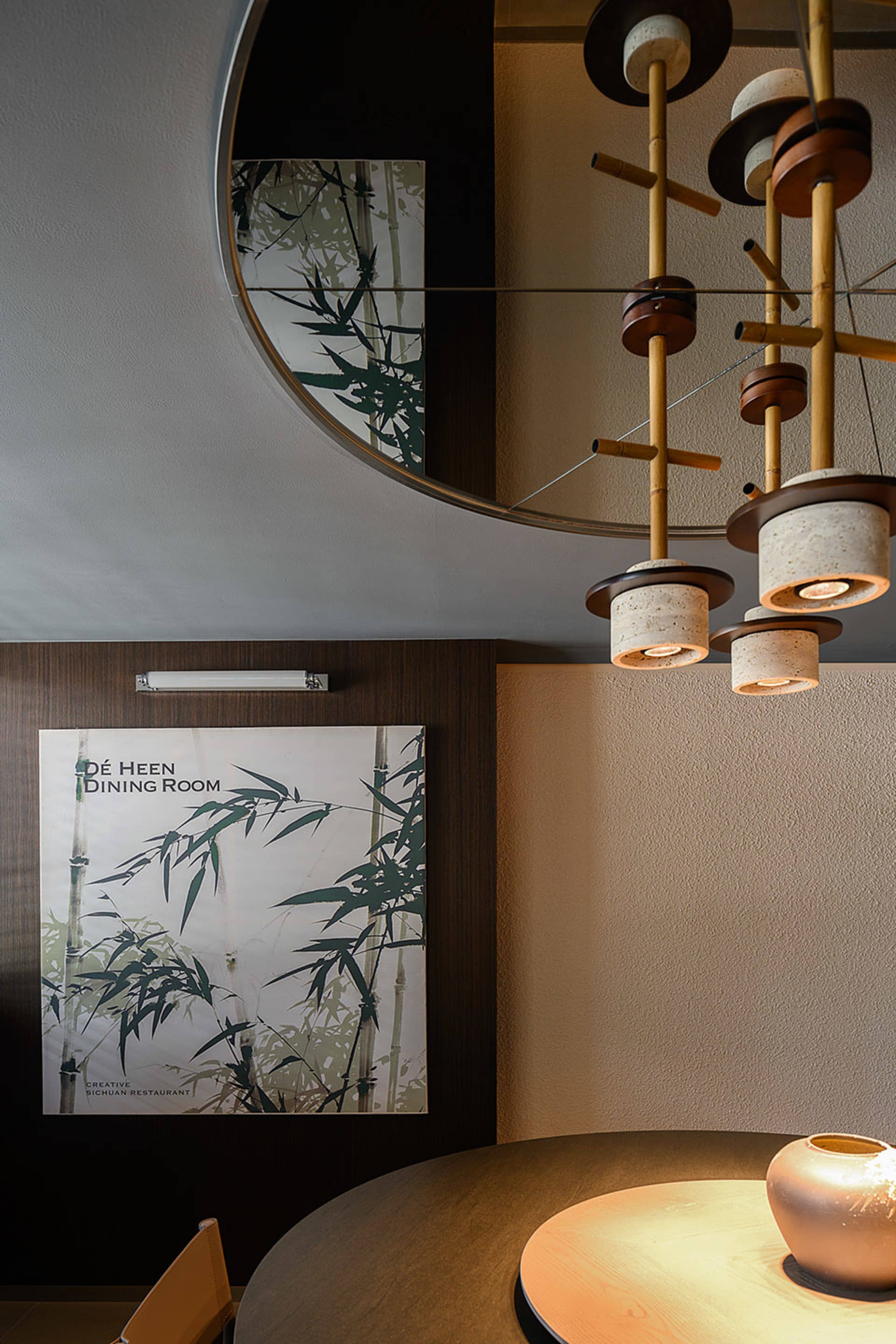 Formal dining space with a chandelier, mirror, potted plants, and a clock, illuminated by multiple light sources