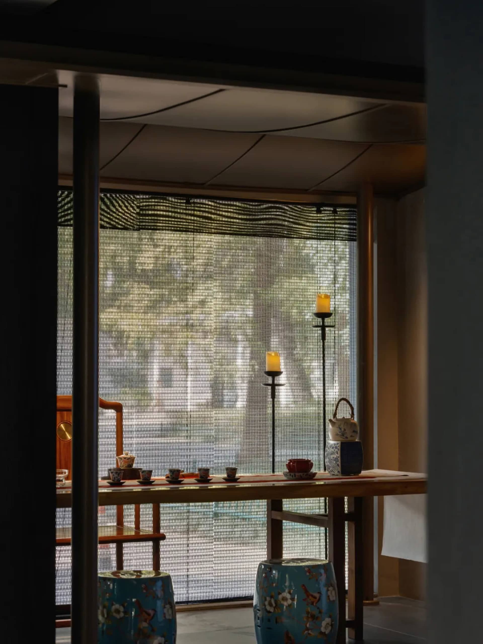 Cozy traditional living and dining space with a wooden dining table, chairs, and classic furnishings, dimly lit