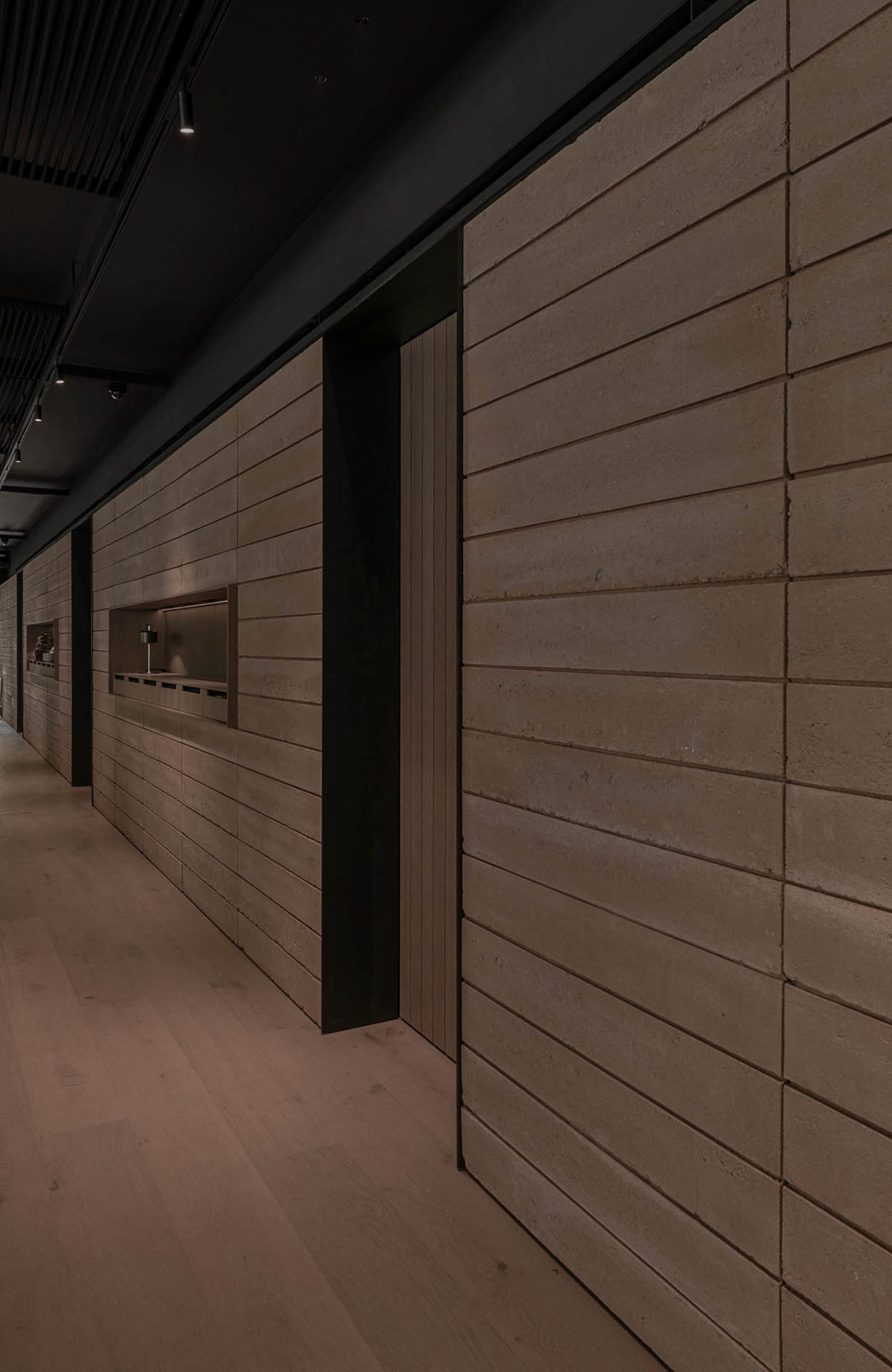 A plain hallway with cement block walls, two doors, and a focus on functionality